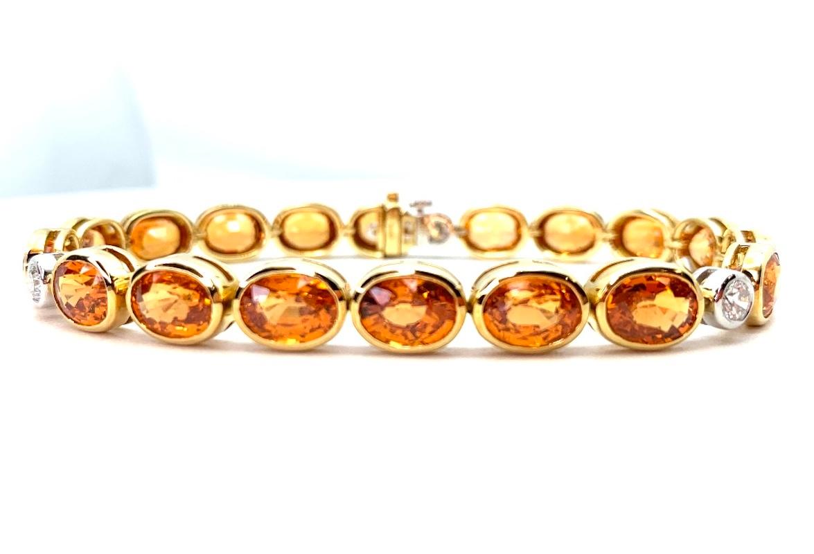 This stunning tennis bracelet features over 35 carats of extremely brilliant, gem-quality Mandarin garnets, bezel set in 18k yellow gold! “Mandarin” is the name given to a special color of bright orange spessartite garnets originally discovered in