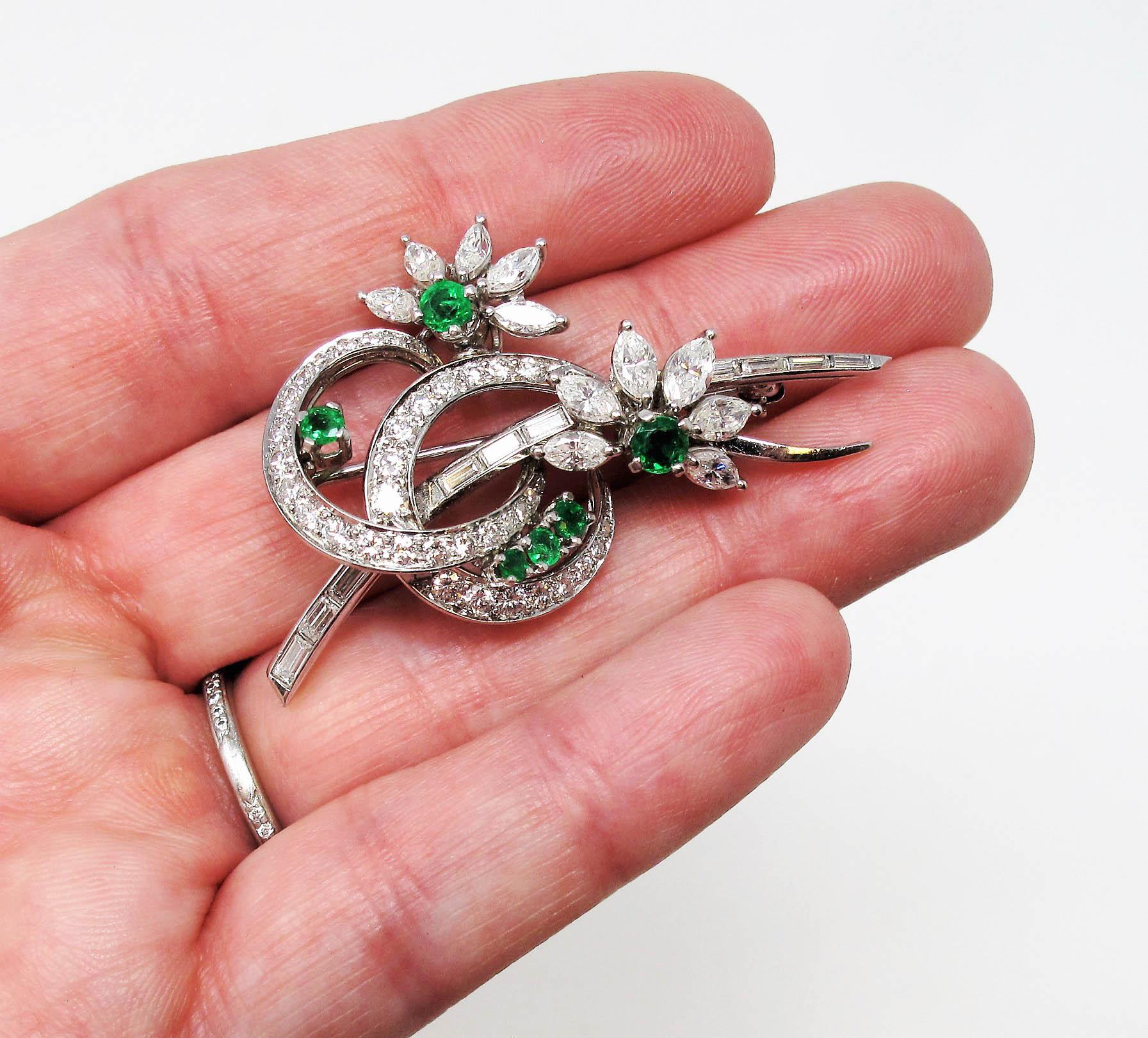 Simply stunning diamond and emerald brooch. We absolutely love the timeless style of this versatile brooch. Shimmering with bright green emeralds and over 50 icy white diamonds, this elegant brooch will add just the right amount of sparkle and style