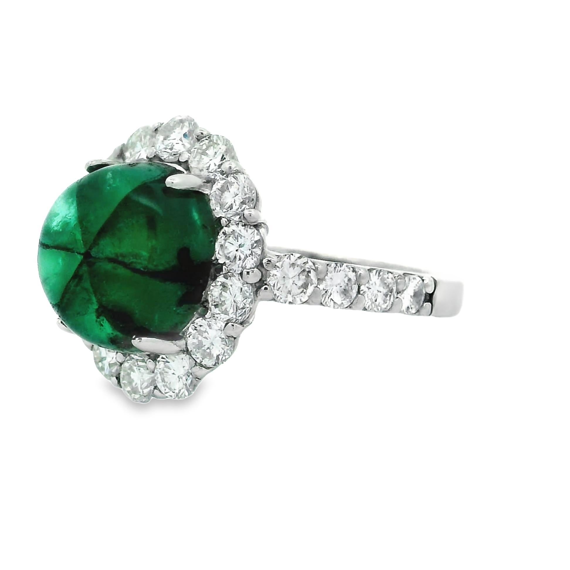 A rare and unique 3.59 carat of Trapiche Emerald takes center stage! It is a rare variety of Emerald characterized by a six-arm radial pattern of usually black spokes separating areas of green emerald. Most Trapiche emeralds come from the emerald