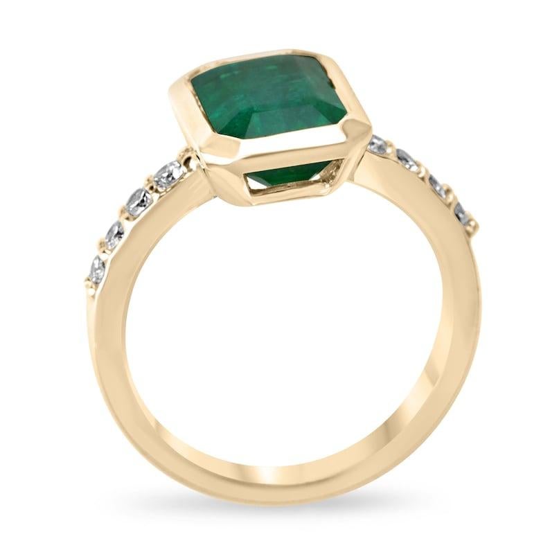 Elevate your elegance with our emerald and diamond accent ring, showcasing a vertically set emerald-cut emerald in a bezel setting, radiating a deep, rich green color with semi-transparent clarity. The shank is adorned with pave-set diamond accents,