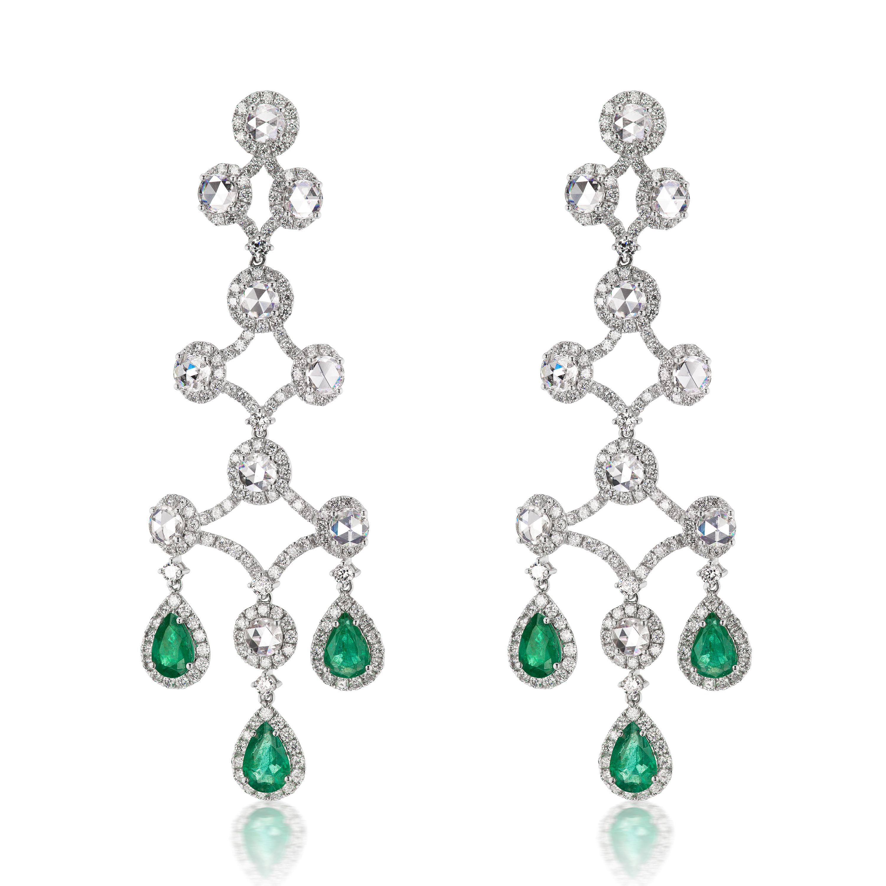 Promising you a scintillating look, these Nigaam earrings are designed by master craftsmen in 18K White Gold. Displaying a chandelier pattern, this pair is set with 8.38 Cts diamonds and 3.85 Cts pear-shaped Emeralds dropping down at the bottom.