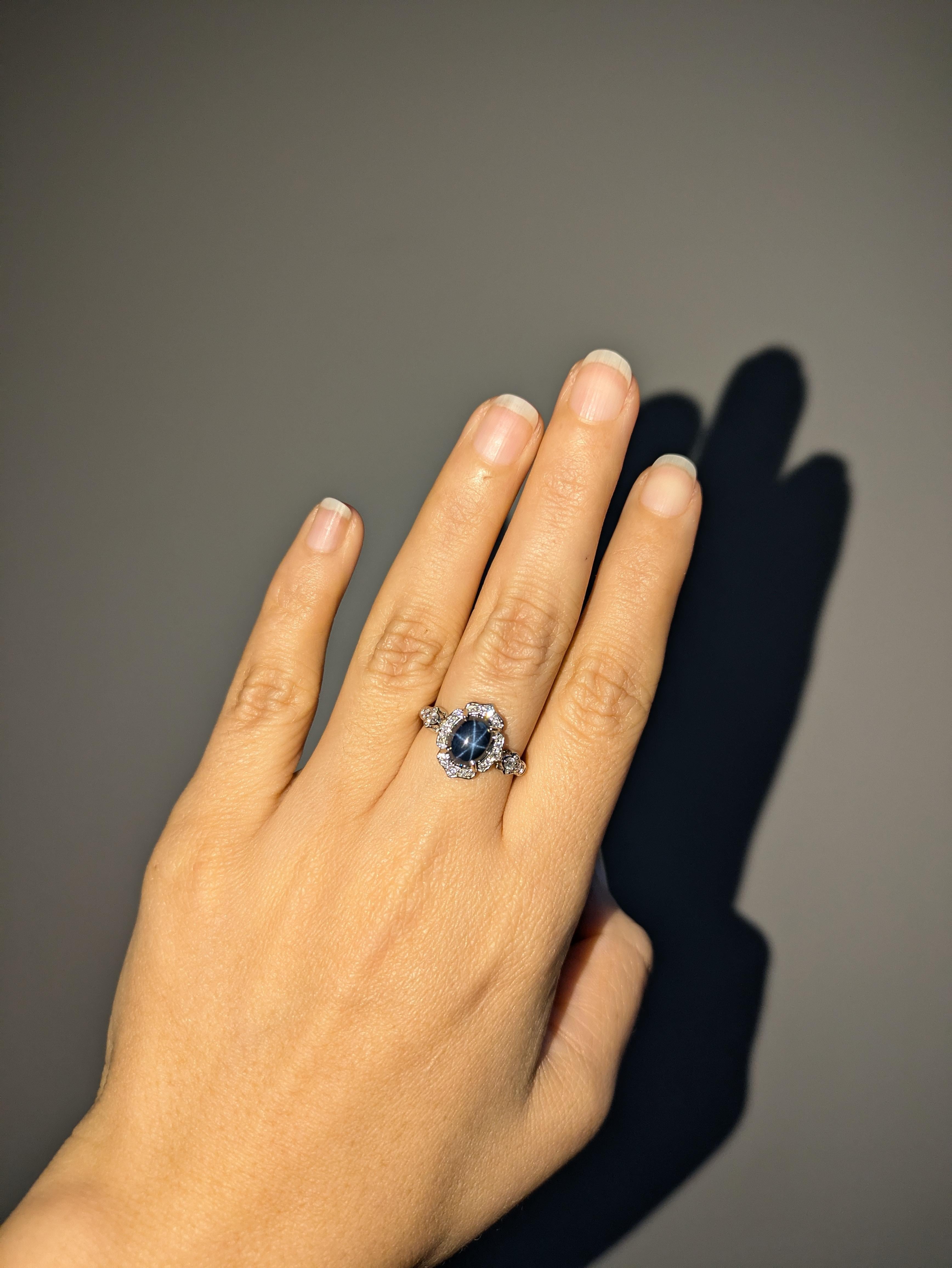 This elegant 14k gold ring (3.45g) features a captivating 3.55-carat oval star sapphire from Ceylon (9x7mm), showcasing a natural six-rayed star that dances across the surface. Surrounded by 24 sparkling diamonds totaling 0.35cttw, this piece