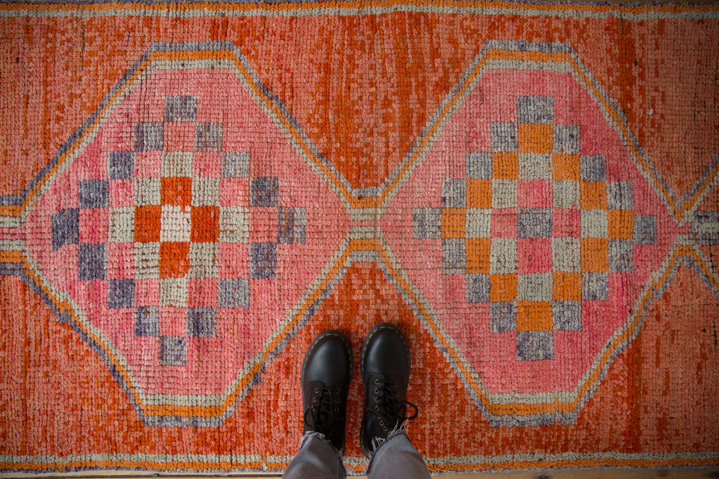 :: Single column triple center medallions interconnected with interior checker design motif atop abrashed ground. Colors and shades include: Tangerine orange, bright bubble bum pink, pale rust, terracotta, oxidized silver, dark dusty faded purple