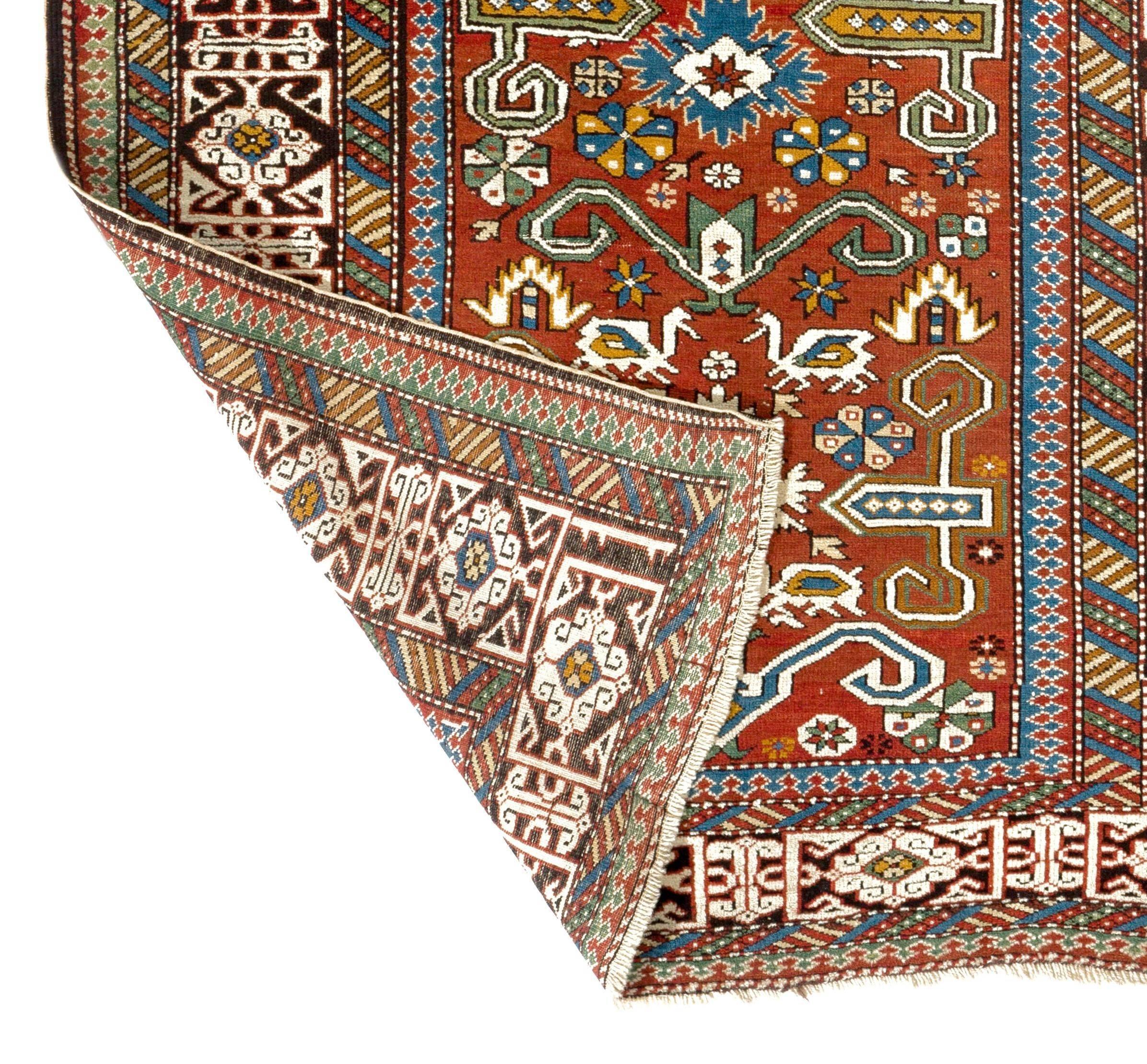 Antique North East Caucasian Perepedil rug from the region of Quba in Azerbaijan. Classic all-over rams horn design with flowers, animals and small stars framed by an elegant Kufic border and colorful minor borders.
Even medium wool pile on cotton