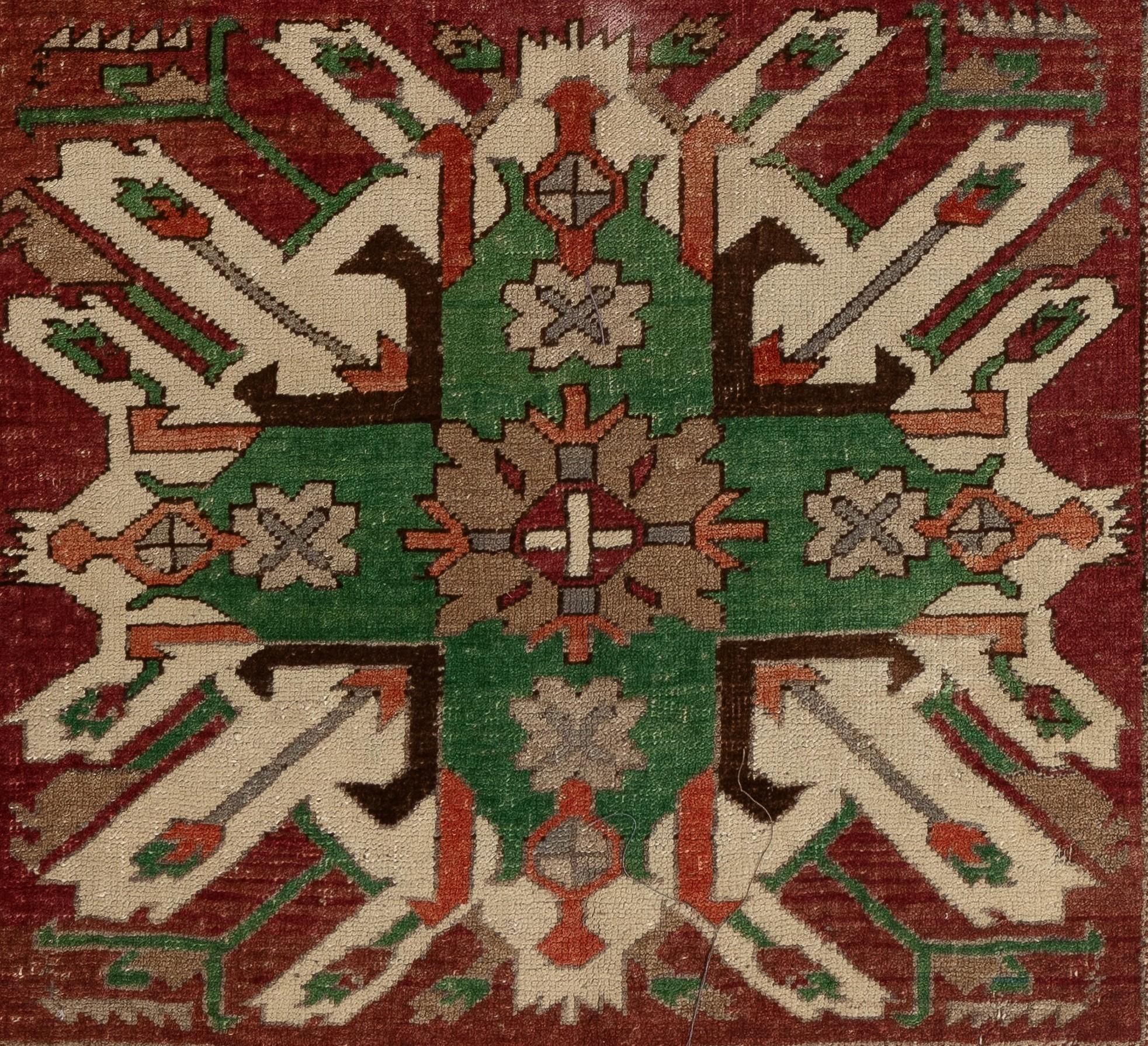 A vintage 1930s Caucasian rug from the village of Chelaberd in Southern Karabakh. This highly popular so called Sunburst or Eagle Kazak design rugs are some of the most collectible and sought after ones among all antique Caucasian works of textile