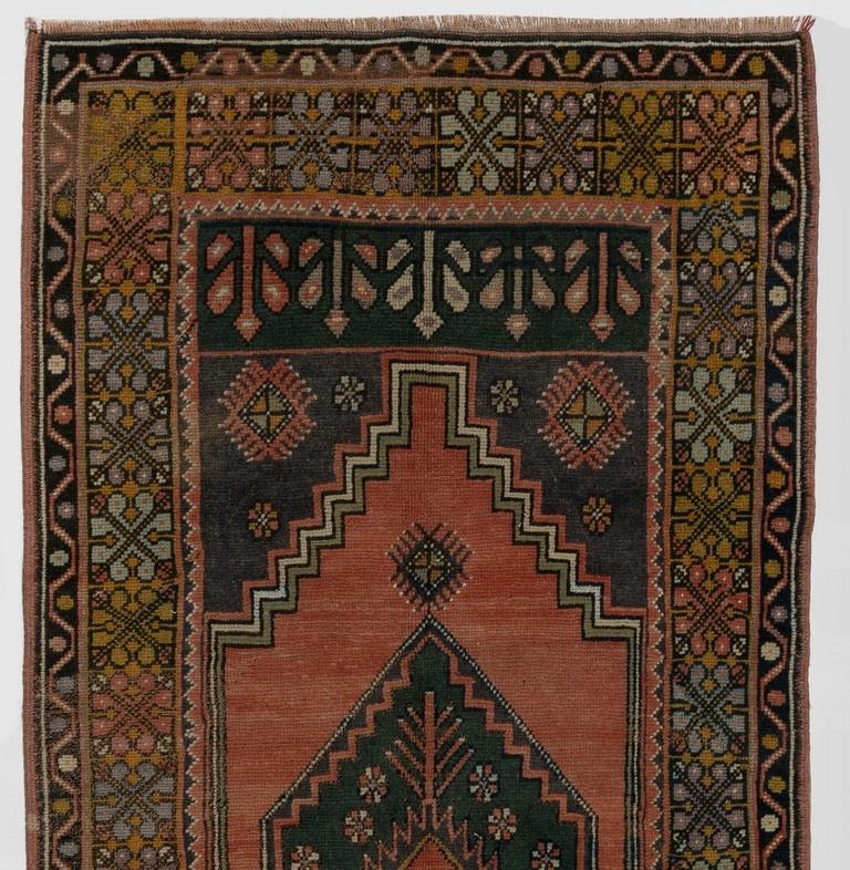 A finely hand-knotted vintage Turkish carpet from 1960s featuring a geometric medallion design. The rug has even low wool pile on cotton foundation. It is heavy and lays flat on the floor, in very good condition with no issues. It has been washed