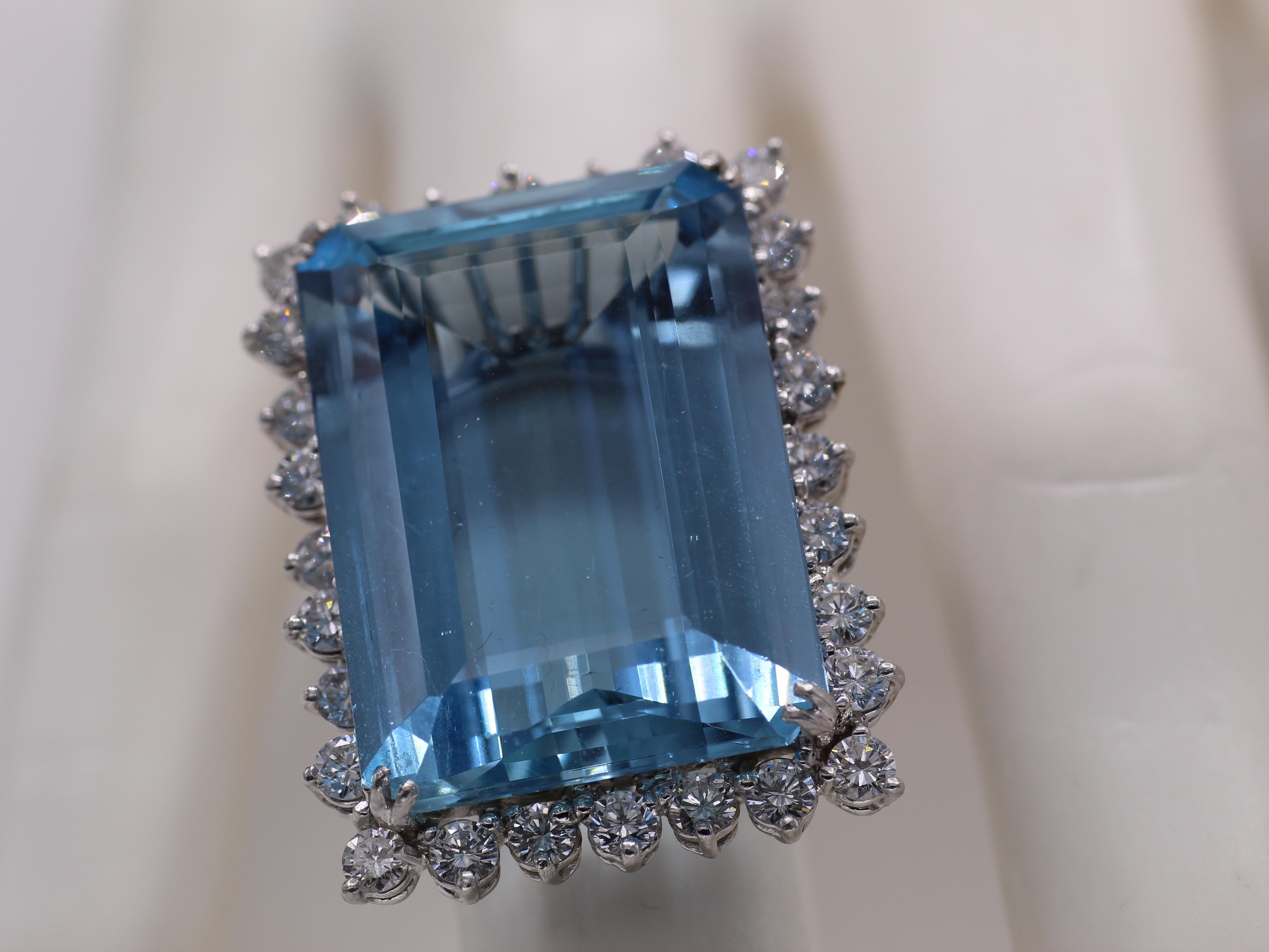 A gorgeous perfectly cut rectangular deep sky-blue Aquamarine is the centerpiece of this well handcrafted 1960s cocktail ring. The Aquamarine is measured to weigh approximately 36 carats and appears much larger than gemstones of similar weight, due