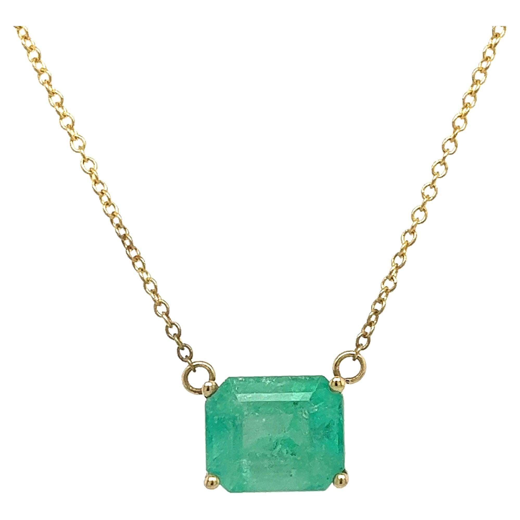 3.66 carat natural Colombian emerald solitaire pendant, gracefully set in a 14K yellow gold cable chain necklace. The pendant features a chic east-west horizontally set center stone. Necklace features an adjustable-length cable chain, offering a