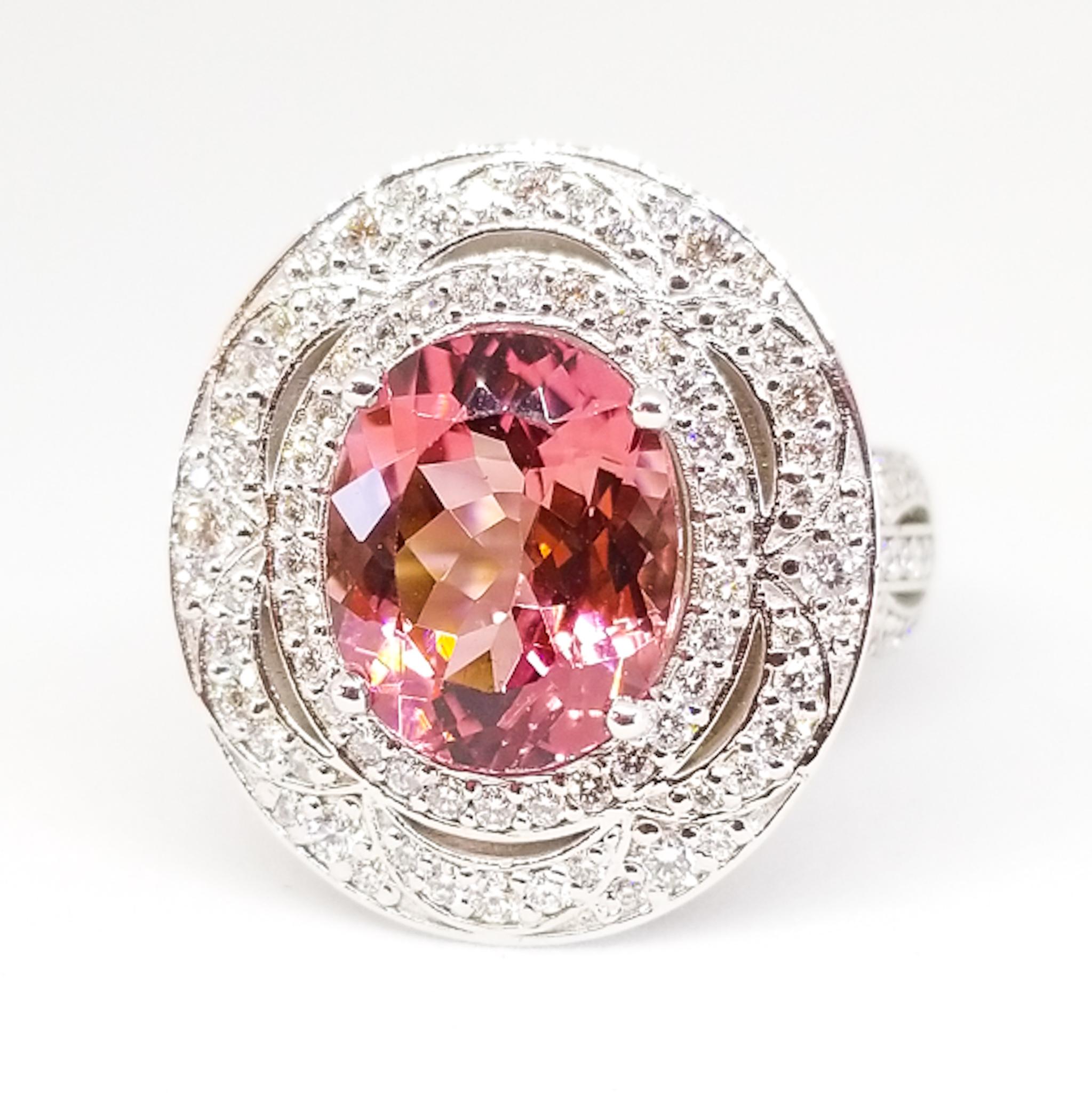 A 3.60 Carat Natural Oval Hot Pink Tourmaline, Gem Clarity and Exceptional Cutting is the centerpiece of this Magnificently detailed cocktail ring. The brilliant cut center stone of 11.8mm high, x 9.7mm wide and 6.2mm deep has a weight of 3.60