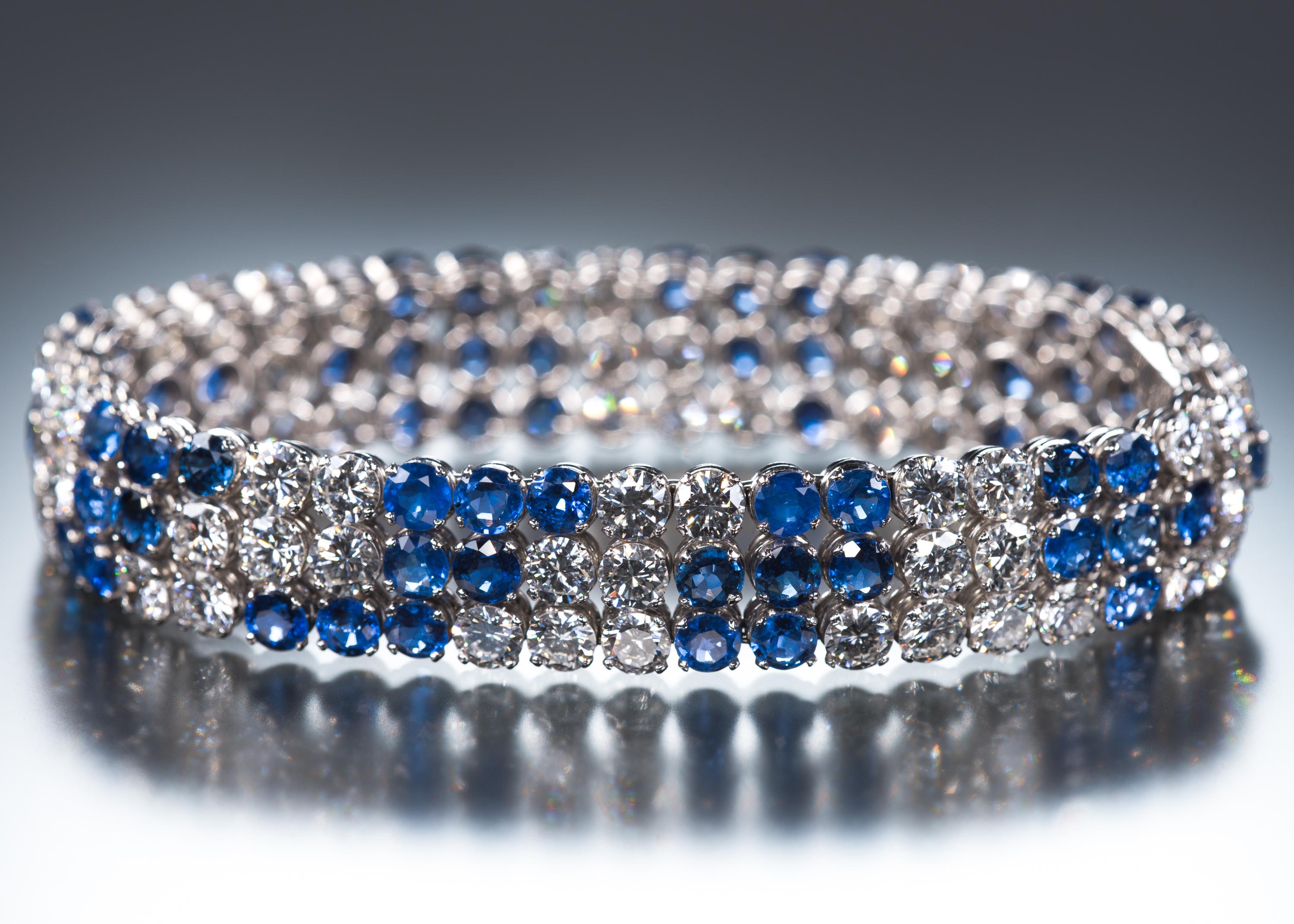 This exceedingly wearable bracelet is comprised of 18.30 carats of medium blue highly saturated sapphires and 18.60 carats of lively diamonds set in an unusual random pattern. The stones are all brilliant cut of the same size and are arranged in a