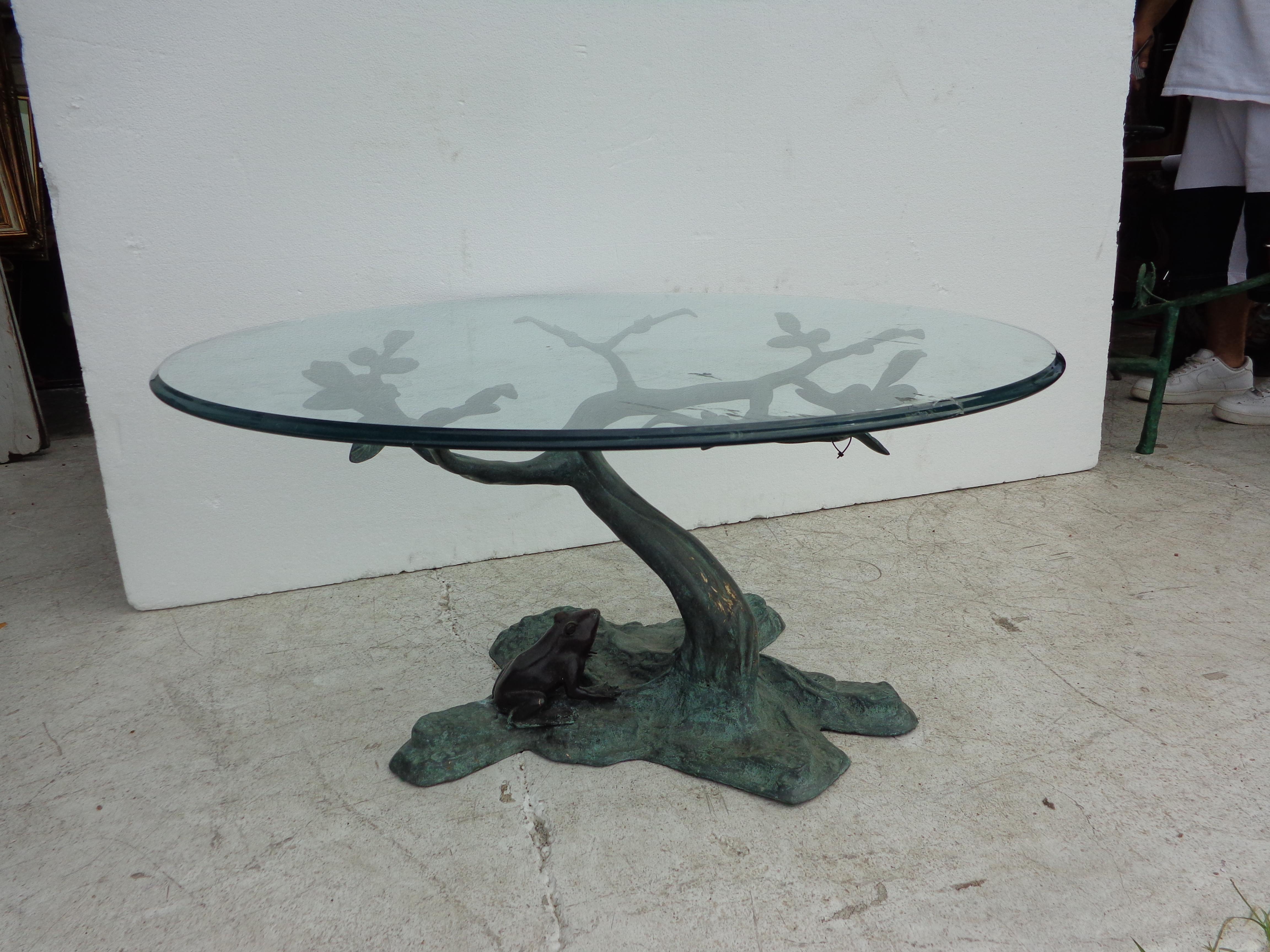 Coffee table inspired by Diego Giacometti

Beautiful hand forged wrought iron with glass top.
Features carved tree branches under glass with a bullfrog looking on. 

The glass top has a small chip. See last photo.