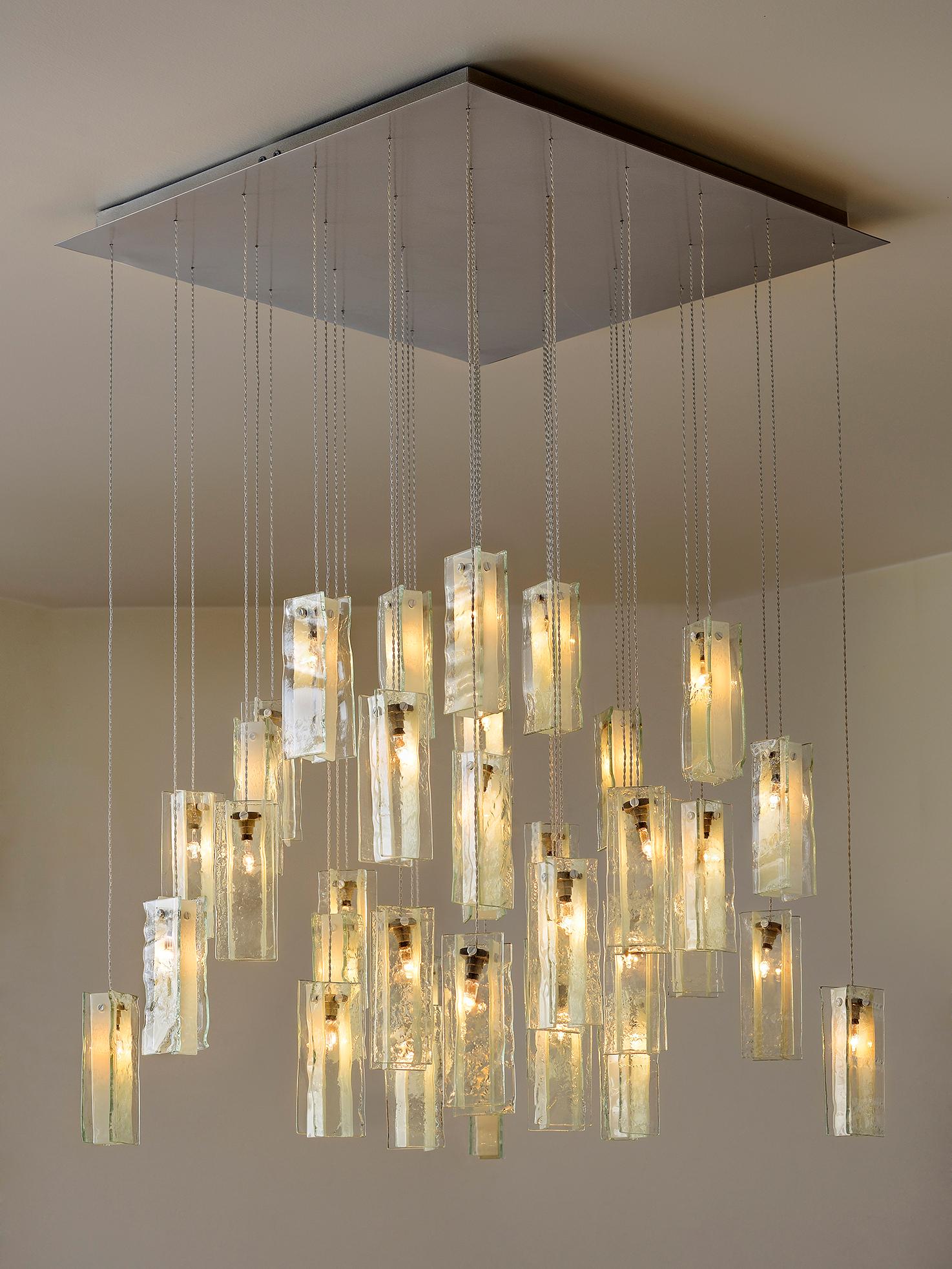 Transform your space with our unique multi-color drops chandelier. This chandelier can be used in all different settings such as a dining room, stairwell illumination, or kitchen pendant lights. Its inherent simplicity adds a versatile and playful