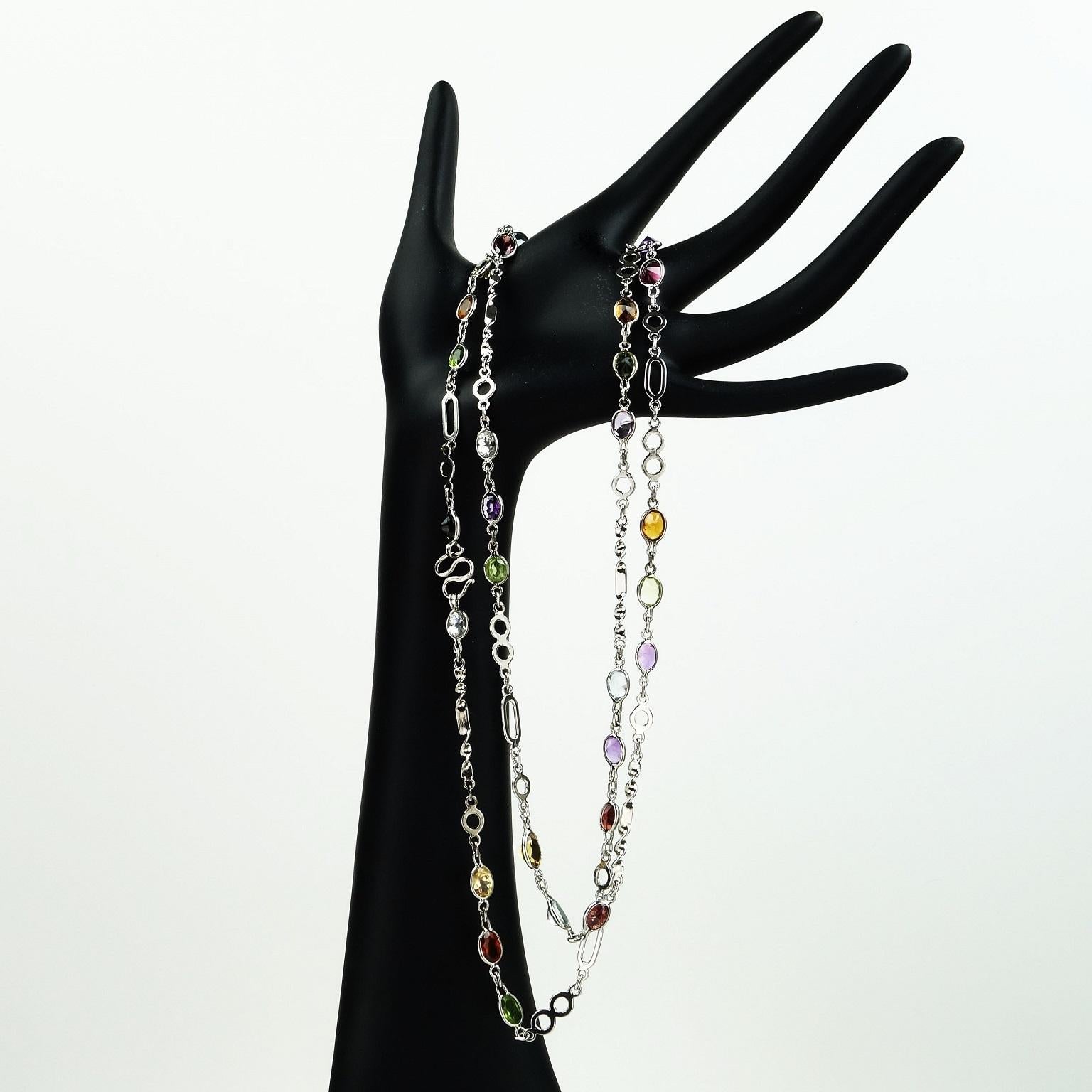 Necklace of Sterling Silver with bursts of oval faceted gemstones. 36 Inches in length is very versatile, this can easily be doubled. The gemstones include amethyst, citrine, peridot, and blue topaz.