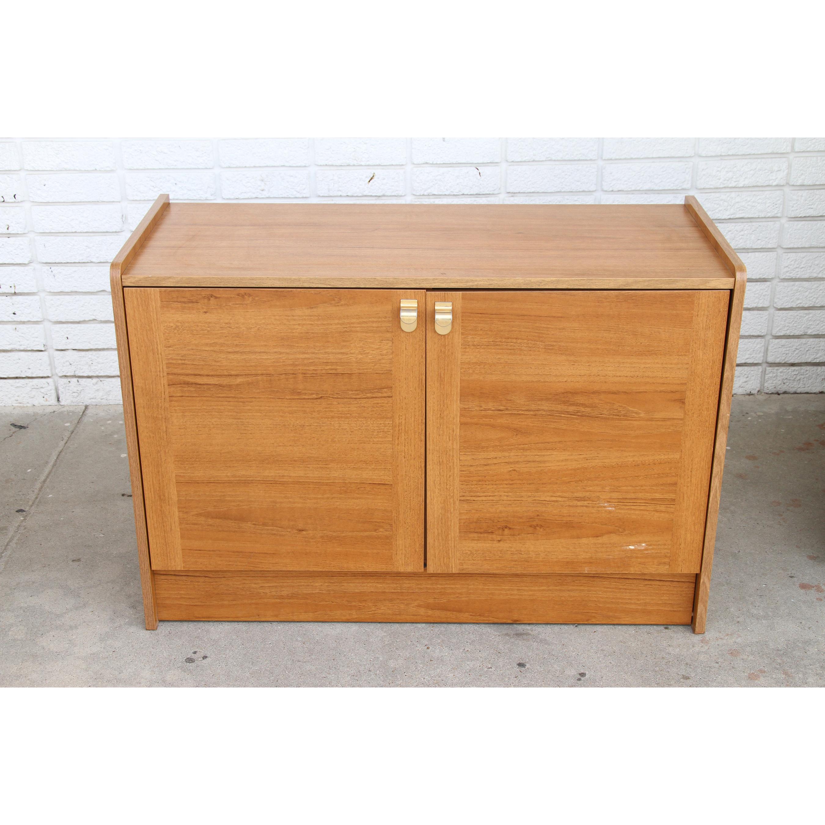 Danish Modern Teak Record Media credenza

Features a pull out shelf for cassettes, compartment for records, and shelving. Brass pulls. Circa mid to late 20th century. 
Measurements: overall: 25