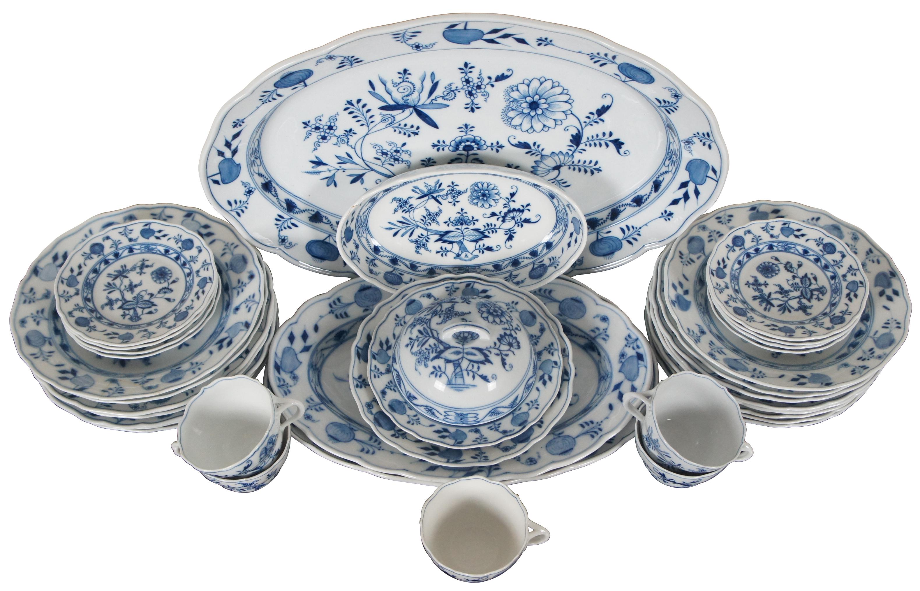 Antique 36 piece set of Meissen flow blue porcelain dinnerware in the Blue Onion pattern with the crossed swords makers mark.

Large Oval Platter - 20.25” x 15.25” x 2.5” / Medium Oval Platter - 15.75” x 11.125” x 2” / Medium Oval Platter - 15.25”