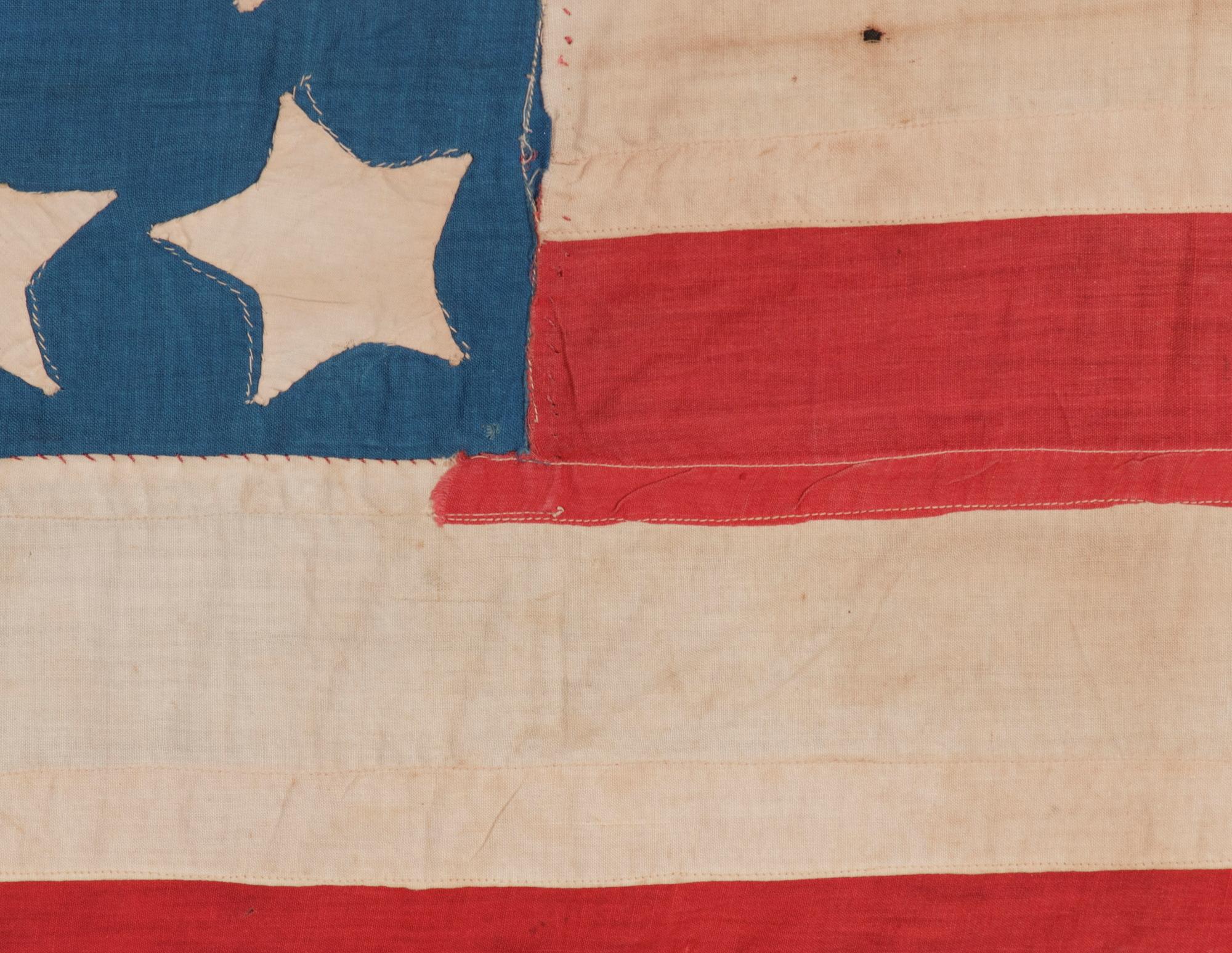 Antique American Flag With 36 Stars On A Cornflower Blue Canton, Civil War Era, 1864-1867, Reflects The Addition Of Nevada As The 36th State; A Great Folk Exaple With Haphazard Rows Of Starfish-like Stars:

36 star American national flag of the