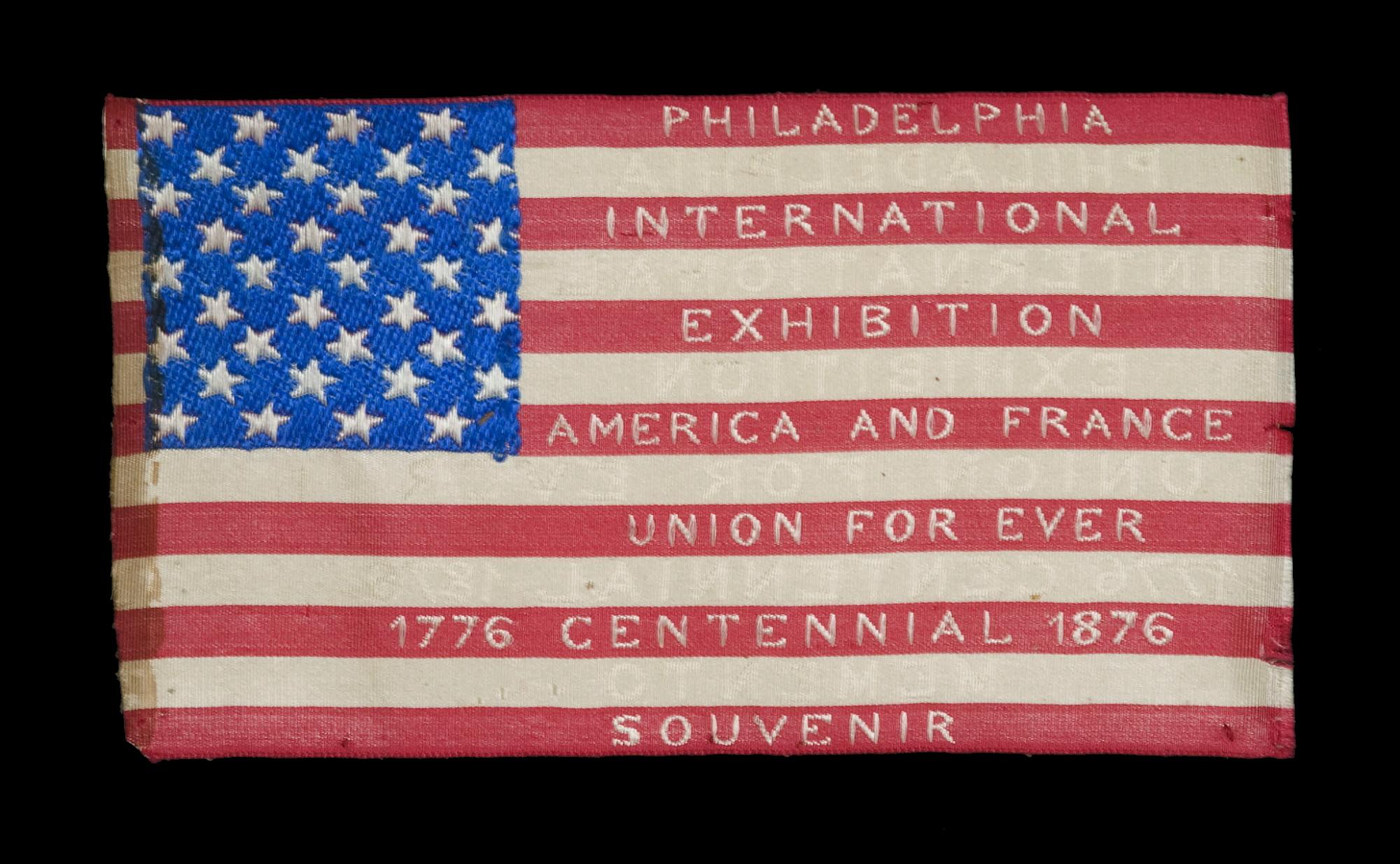 FRENCH-DESIGNED AMERICAN FLAG, WOVEN SILK WITH TEXT ON BOTH SIDES, PRODUCED FOR THE 100TH ANNIVERSARY OF AMERICAN INDEPENDENCE; LIKELY MADE IN PHILADELPHIA AT THE 1876 CENTENNIAL INTERNATIONAL EXPOSITION

American national flag, made of silk,