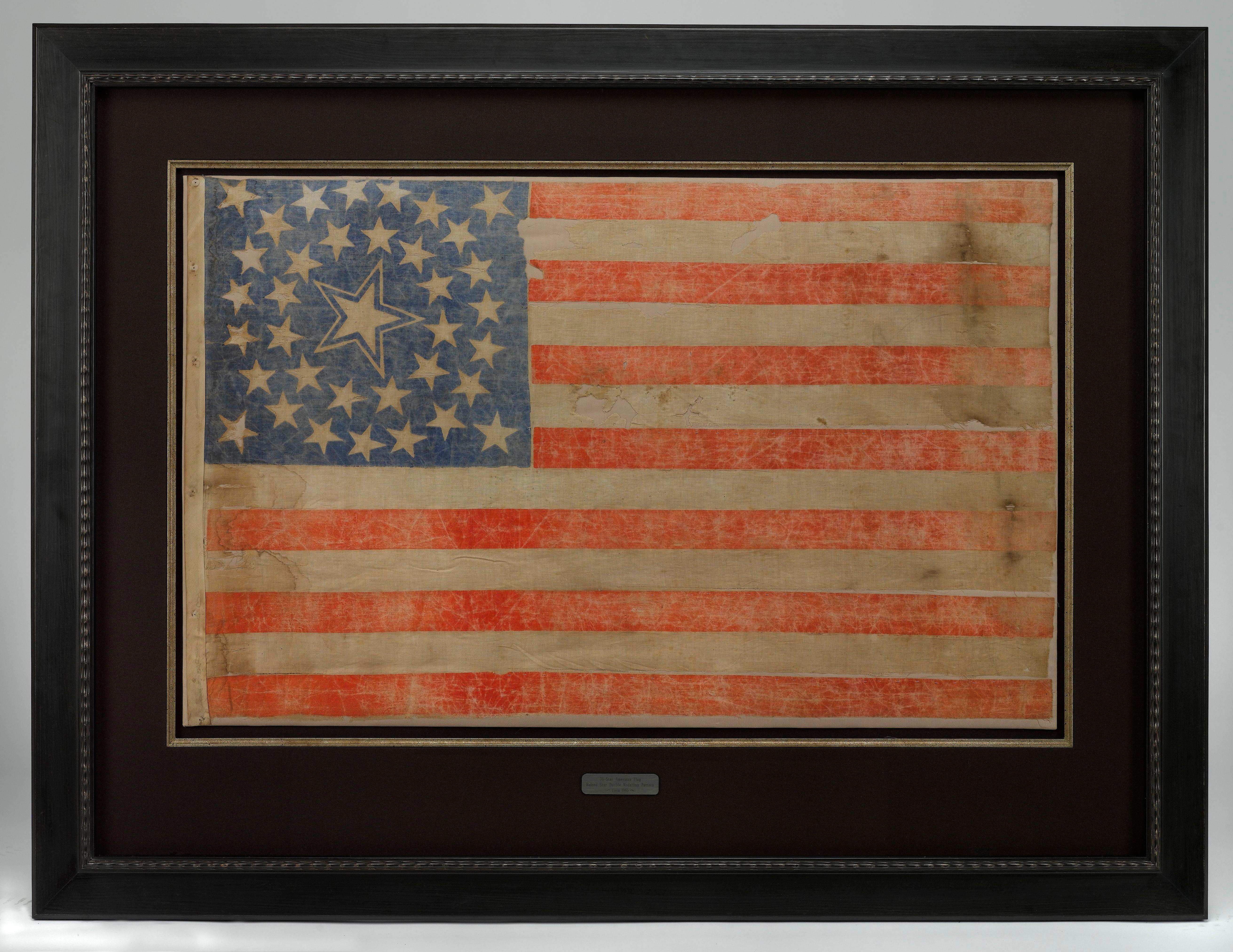 This 36-star flag has stars arranged in a gorgeous and highly desirable medallion pattern.  This particular medallion includes a large haloed star in the middle, two rings of stars surrounding the large star, and a flanking star in each corner