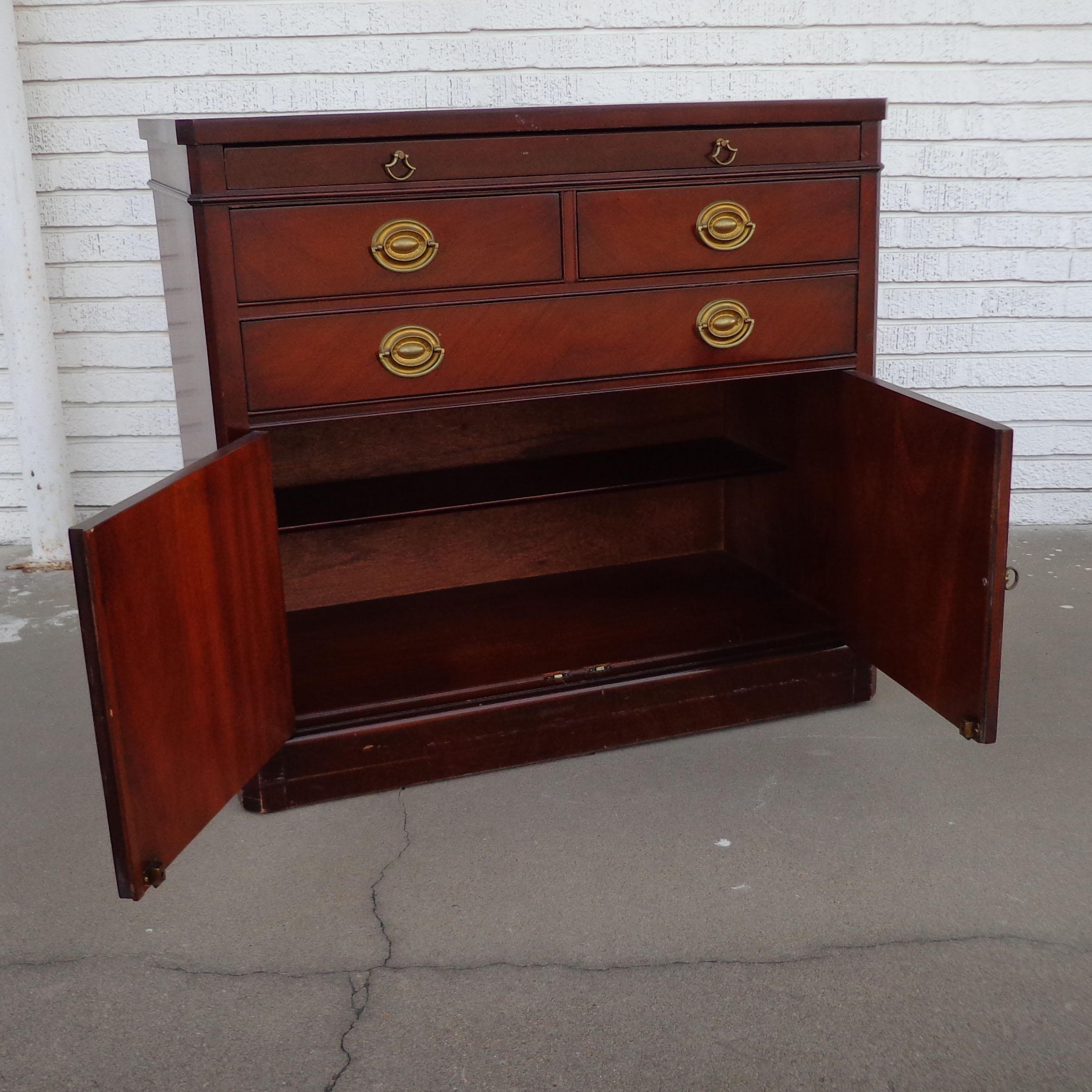 Travis Court Drexel buffet 
 Georgian style mahogany buffet cabinet featuring 3 drawers and shelving below. Brass pulls. 

Measures: 36