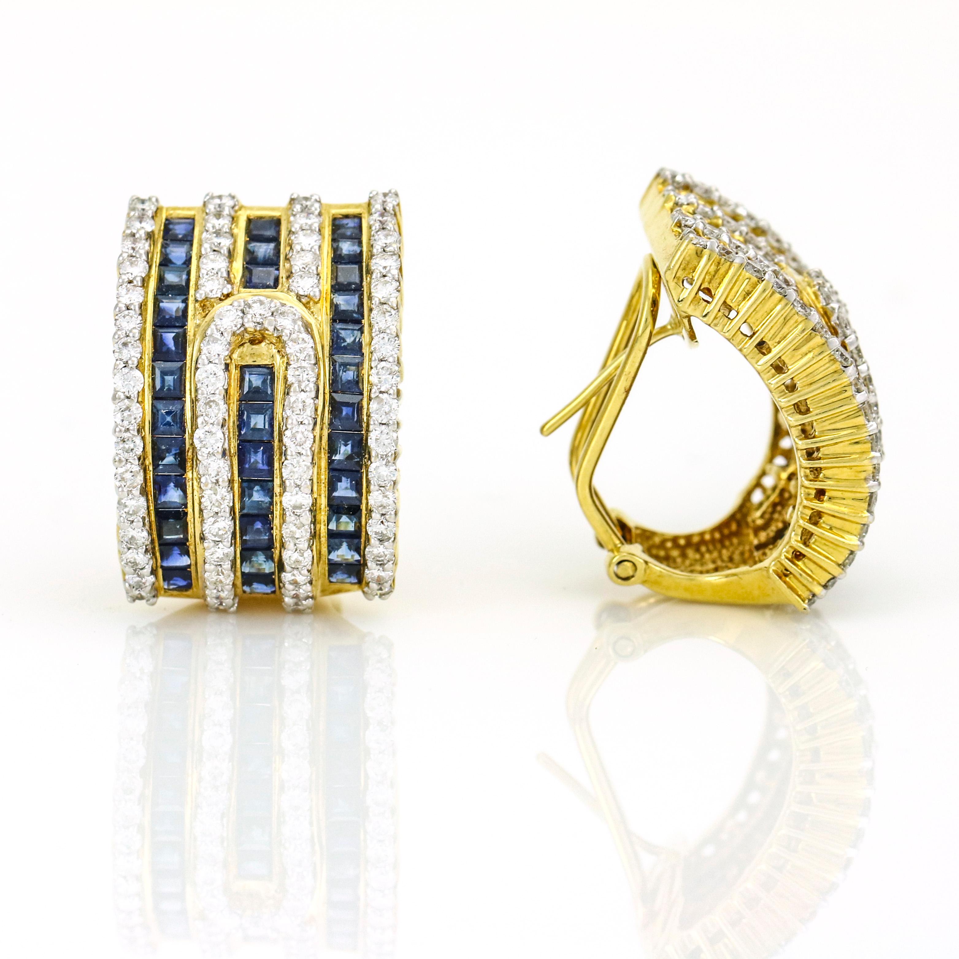 Retro half-hoop earrings channel set with princess-cut blue sapphires and prong set with round diamonds crafted in 18 karat yellow gold. Omega backs. Estimated total carat weight of diamonds, 1.45 carats. Approximate carat weight of sapphires, 2.15