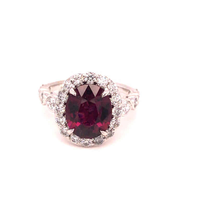 Center: 3.60 carats oval cut raspberry garnet
Diamonds: rounds and two pears at the shoulders total 1.16 carats
Set in 18k White Gold
Ring size 6.5 but can be sized up or down to your specification at no charge