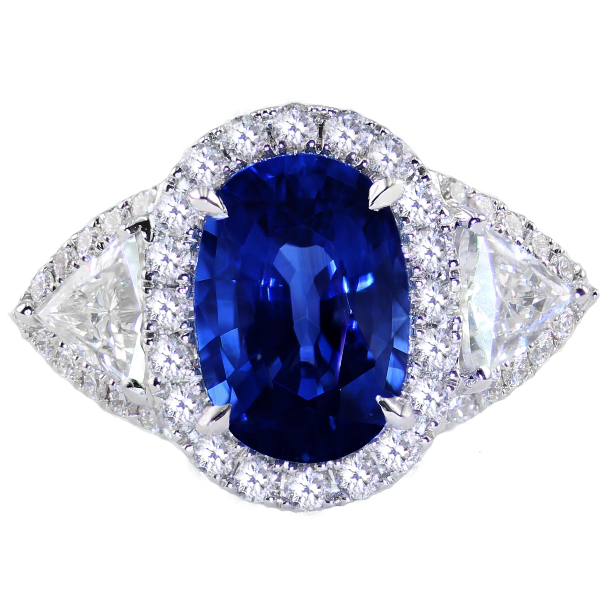 3.60 carat oval cut blue sapphire center, set between two trillion cut diamonds and 80 round diamonds (total diamond weight 1.94 carats).

Be sure to shine from every angle. This ring can be worn as a stunning engagement ring, or a beautiful right