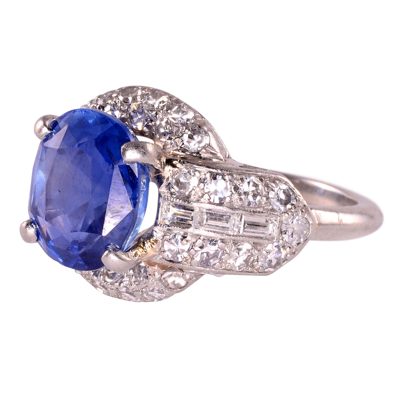 Vintage 3.60 carat oval sapphire and diamond platinum ring, circa 1930. This platinum ring has one center oval sapphire at 3.60 carats. The vintage sapphire ring is accented with 36 single cut diamonds at 0.86 carat total weight having VS1 clarity