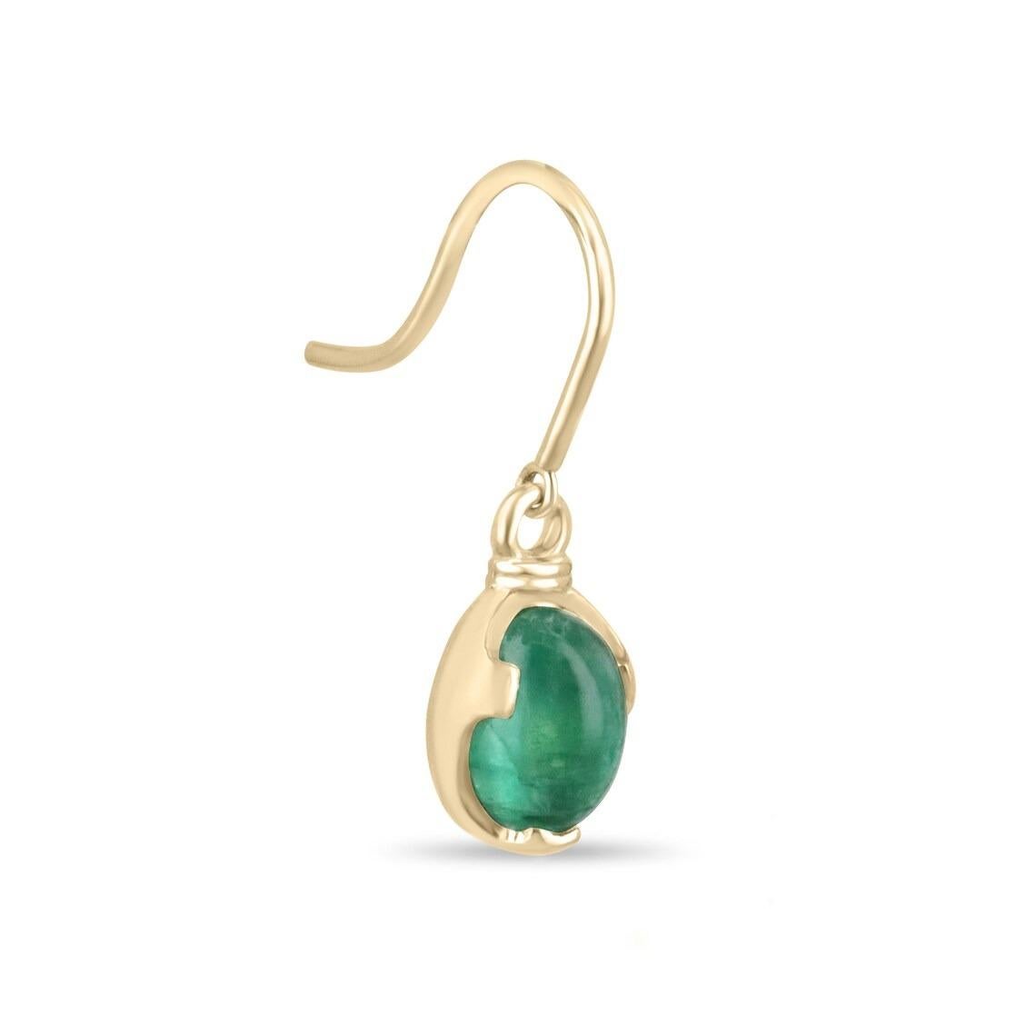 These emerald dangle earrings feature two stunning cabochon cut oval-shaped emeralds, each exhibiting a rich green color and beautiful characteristics. With a combined weight of 3.60 carats, these emeralds captivate the eye with their exceptional