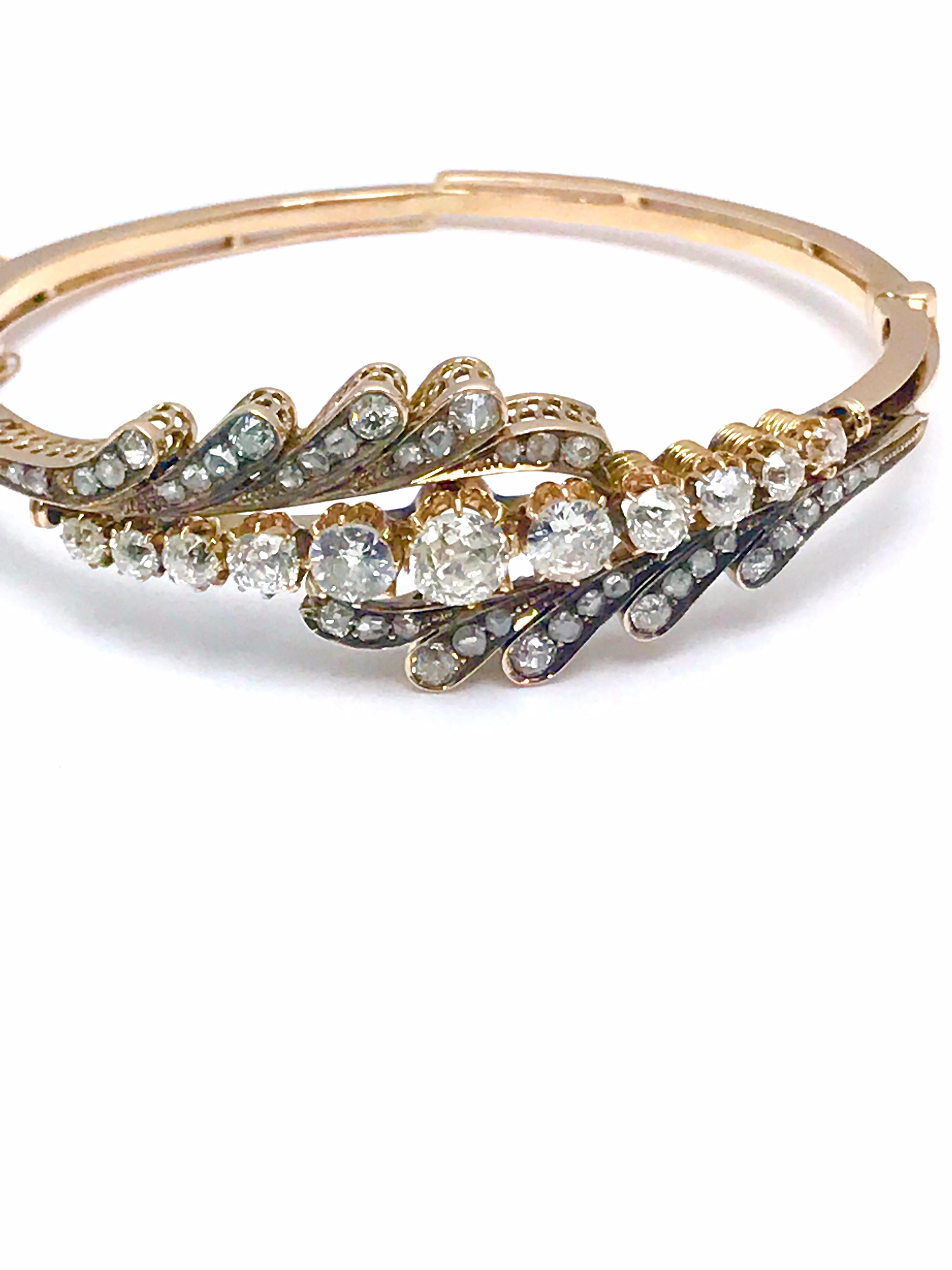 An absolutely stunning 3.61 carat old mine cut and rose cut Diamond bangle bracelet in 14 karat rose gold.  The bracelet is designed with a single row of prong set old mine cut Diamond  going straight through the center, with smaller rose cut