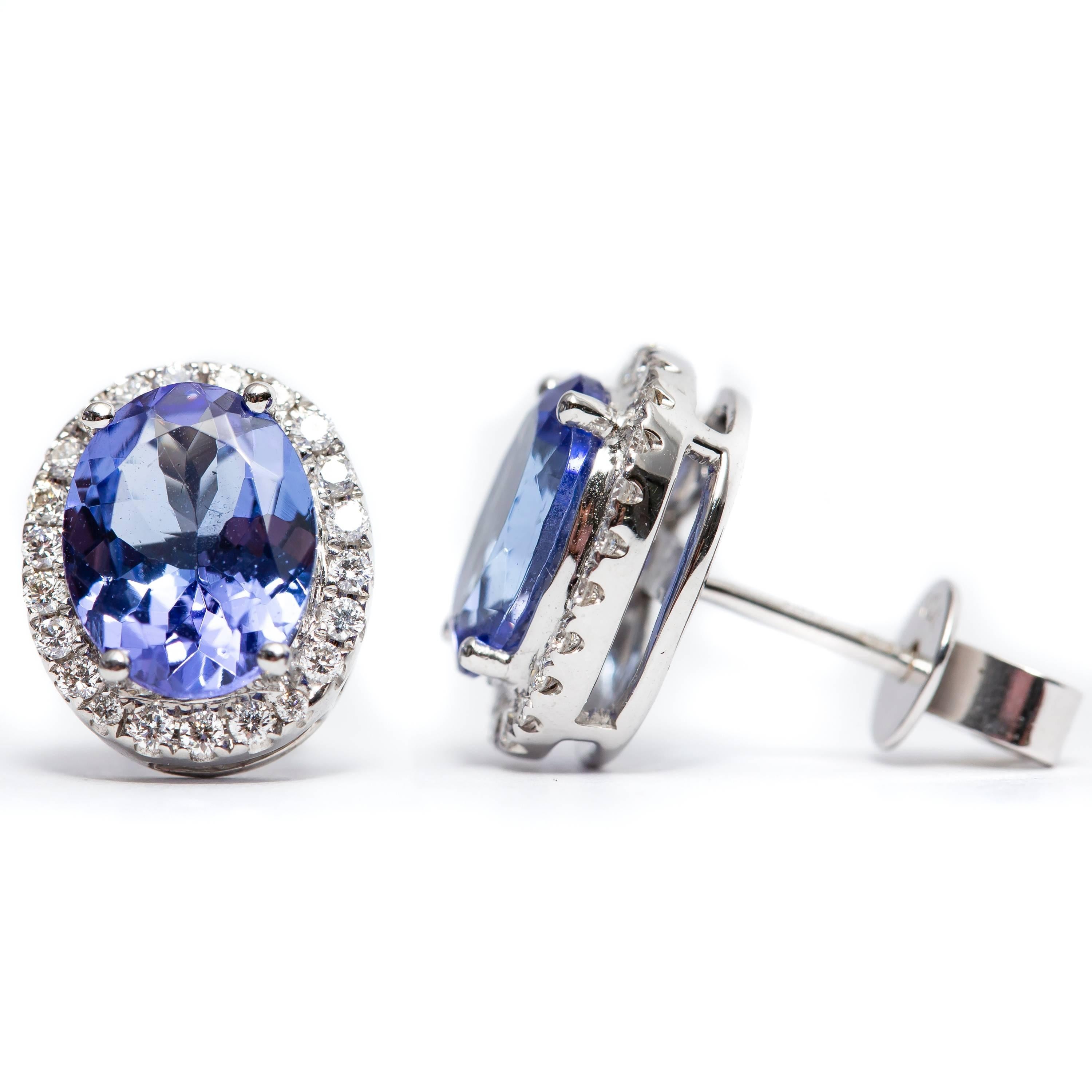 A beautiful pair of 3.61 Carat pear shaped tanzanite earrings featuring 0.35 Carats of Color G Clarity VS1 Round White Brilliant Diamonds. Set in 18 Karat White Gold. These earrings are available in other carat sizes. As well as 18 Karat Yellow and