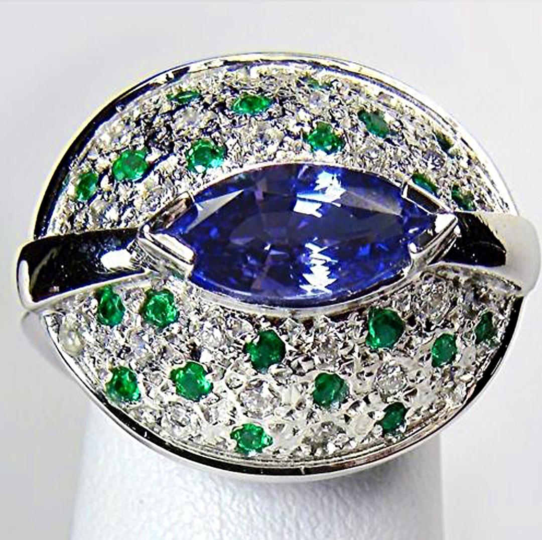 Make a statement with this stunning natural Tanzanite Emerald and Diamond Cocktail Ring, Crafted in 18K white gold, this is a unique and sculptural creation with an elegant 