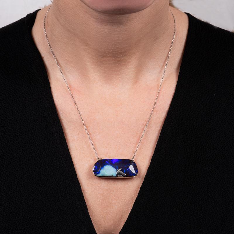 This unique pendant was custom made in house and features a 36.15 carat Boulder opal set in 18 karat white gold. It has an armadillo peeking out on top of the opal. People will be asking about your necklace every time you wear it! It is set on an 18