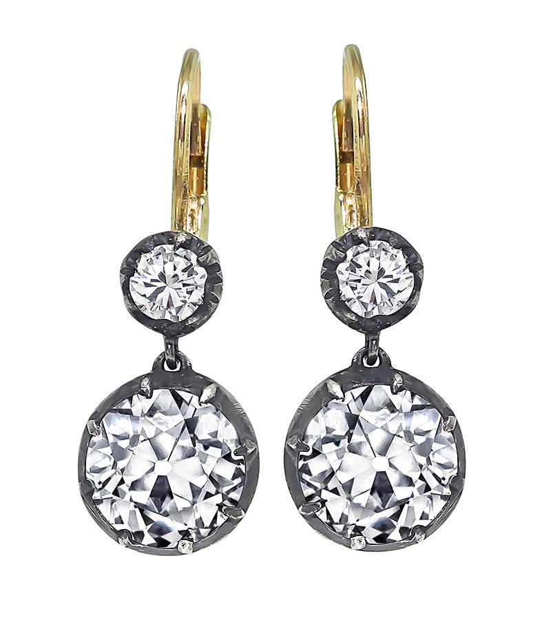 This is an amazing pair of silver and gold earrings from the Victorian era. The earrings feature sparkling old mine cut diamonds that weigh approximately 3.61ct. The color of these diamonds is J-K with VS1 clarity. These diamonds is accentuated by