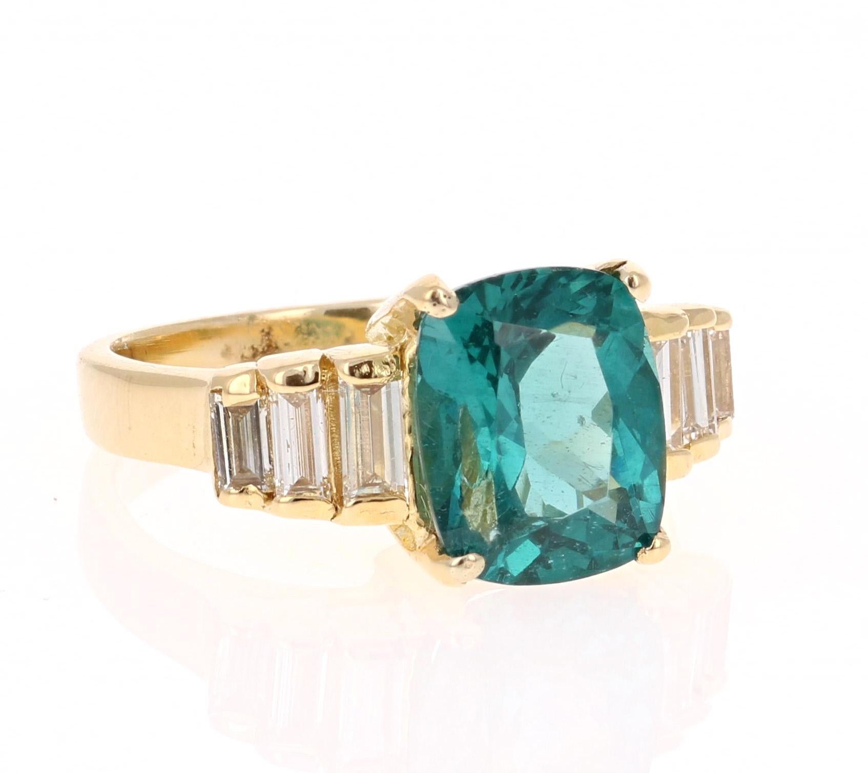 Classic and beautifully designed Apatite and Diamond Ring! 
This ring has a 3.12 carat Cushion Cut Apatite in the center of the ring and is surrounded by 6 Baguette Cut Diamonds that weigh a total of 0.50 carats. The total carat weight of the ring
