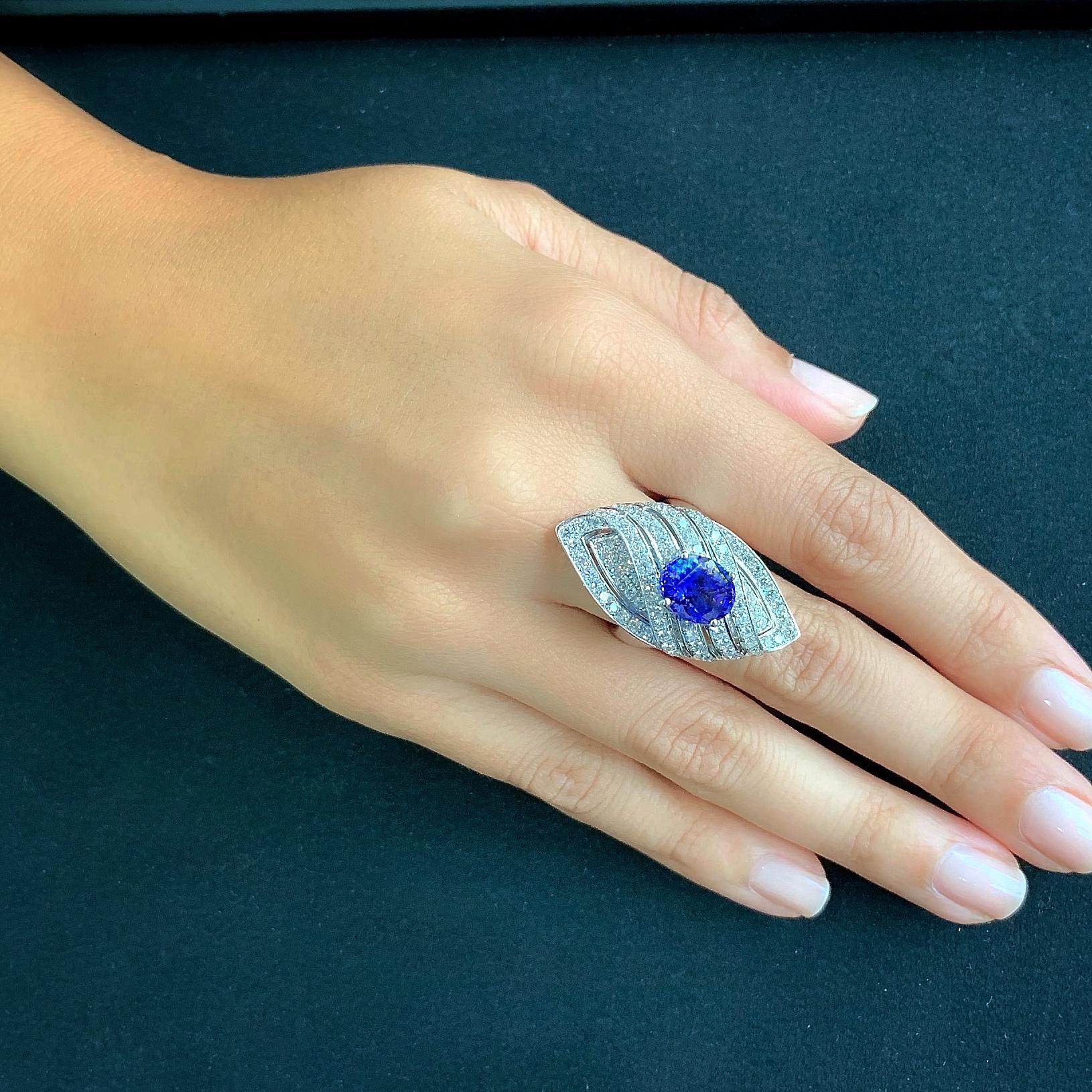 Butani's 18-karat white gold ring is encrusted with 2.08 carats of shimmering white diamonds and centered with a 3.62 carat oval-cut blue tanzanite in a classic marquise setting.  Currently a ring size US 7.  For other sizes, please contact