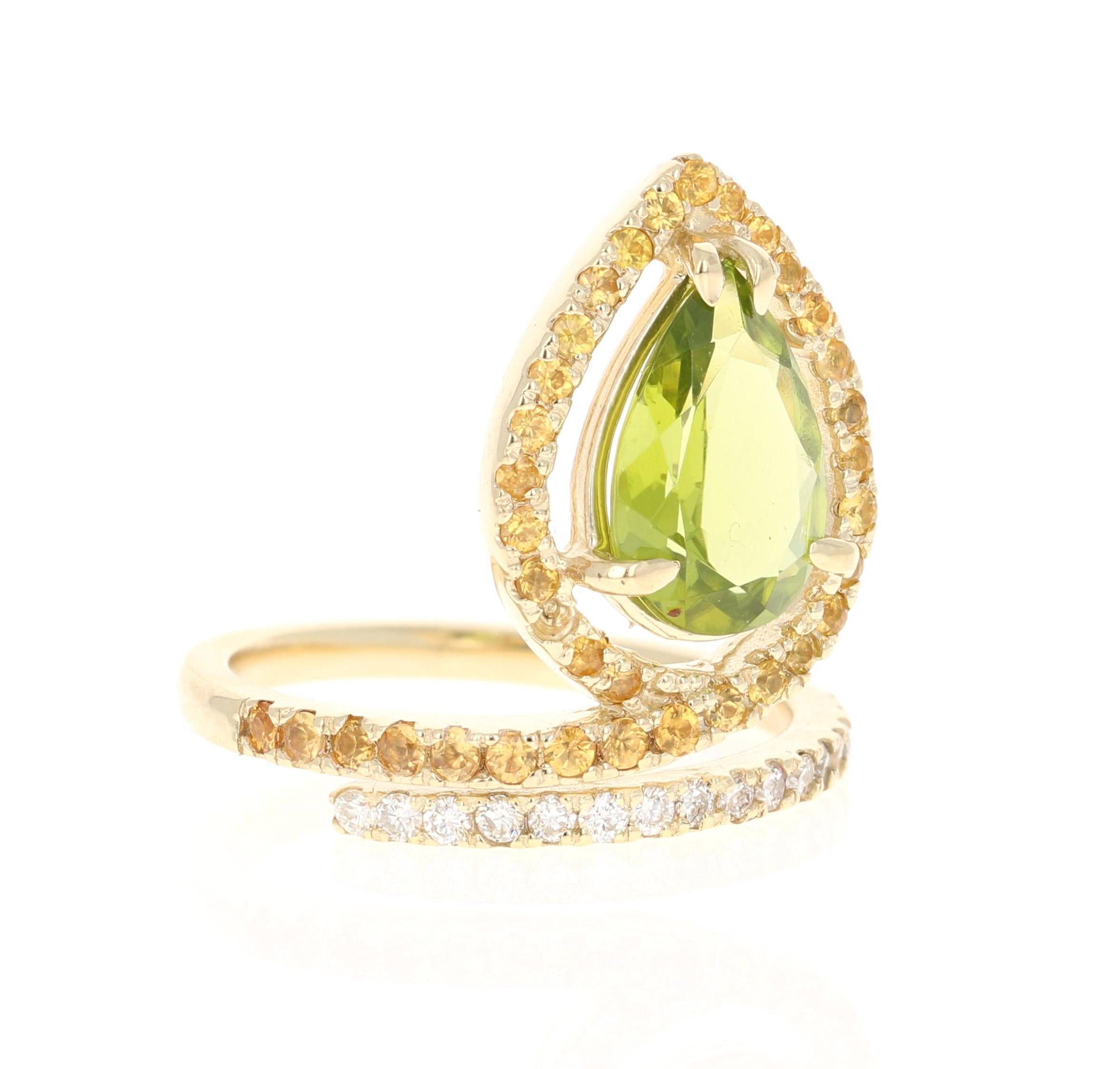 This beautiful ring has a Pear Cut Peridot in the center that weighs 2.61 carats. The ring is surrounded by a halo of yellow sapphires and wraps around with diamonds. There are 35 Yellow Sapphires that weigh 0.72 carats and there are 18 Round Cut
