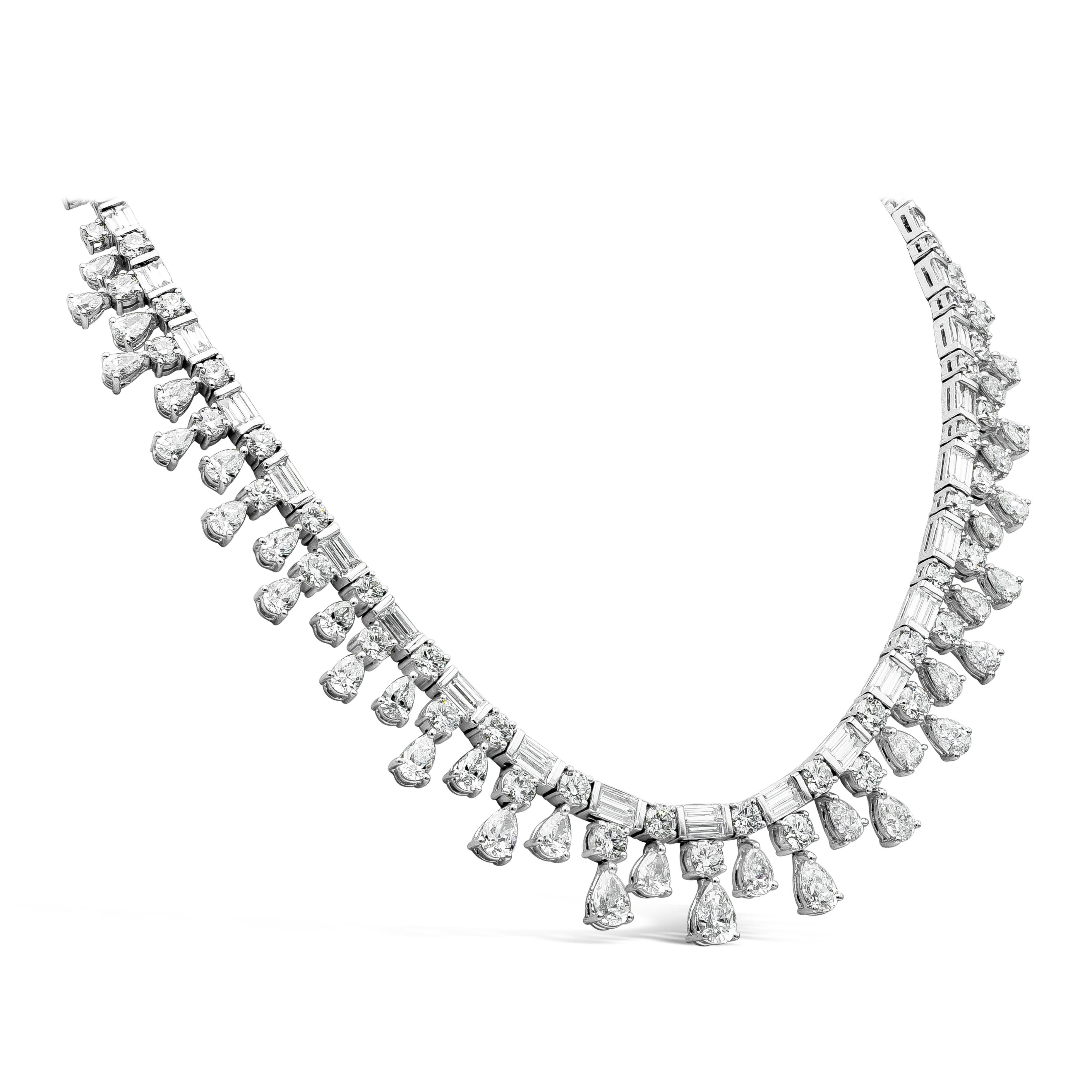 A brilliant and well crafted diamond necklace showcasing a row of alternating baguette and round diamonds in a polished platinum mounting. Pear shape diamond fringes elegantly suspend the line of diamonds. Diamonds weigh 36.28 carats total. Double