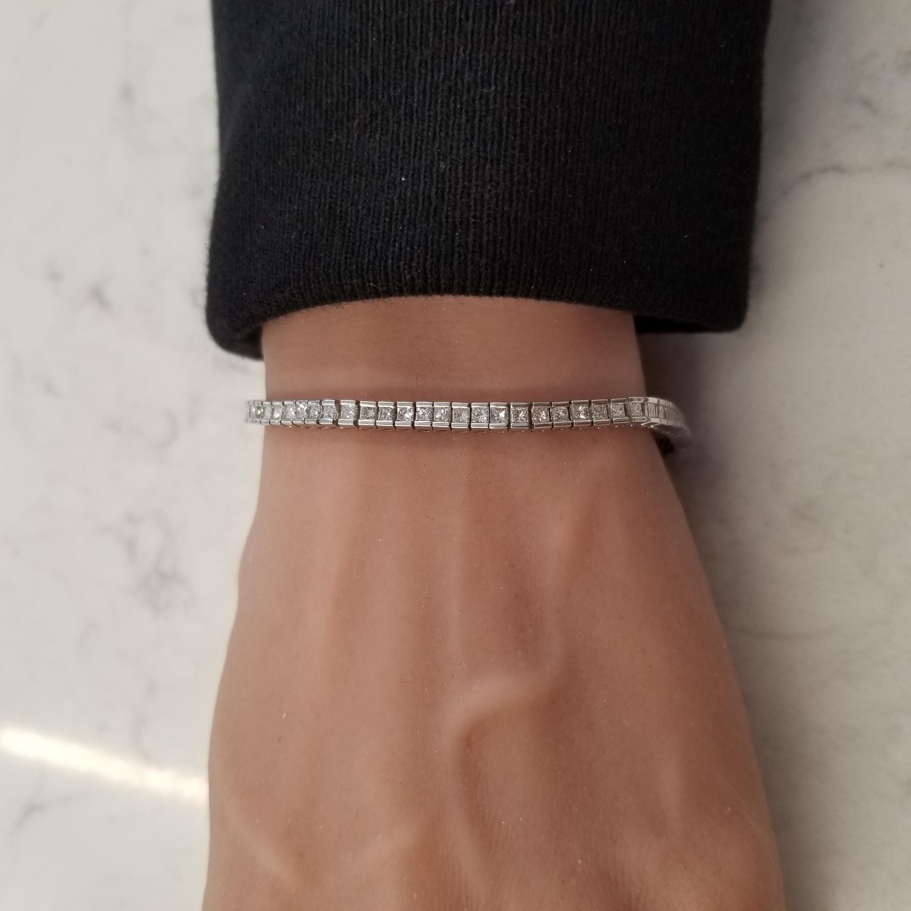 Every stylish lady needs a magnificent diamond bracelet and This. Is. It! This bracelet proudly boasts an astounding 3.62 carat total weight comprised of 77 princess-cut diamonds wrapping gracefully around your wrist. Diamonds are G in color and