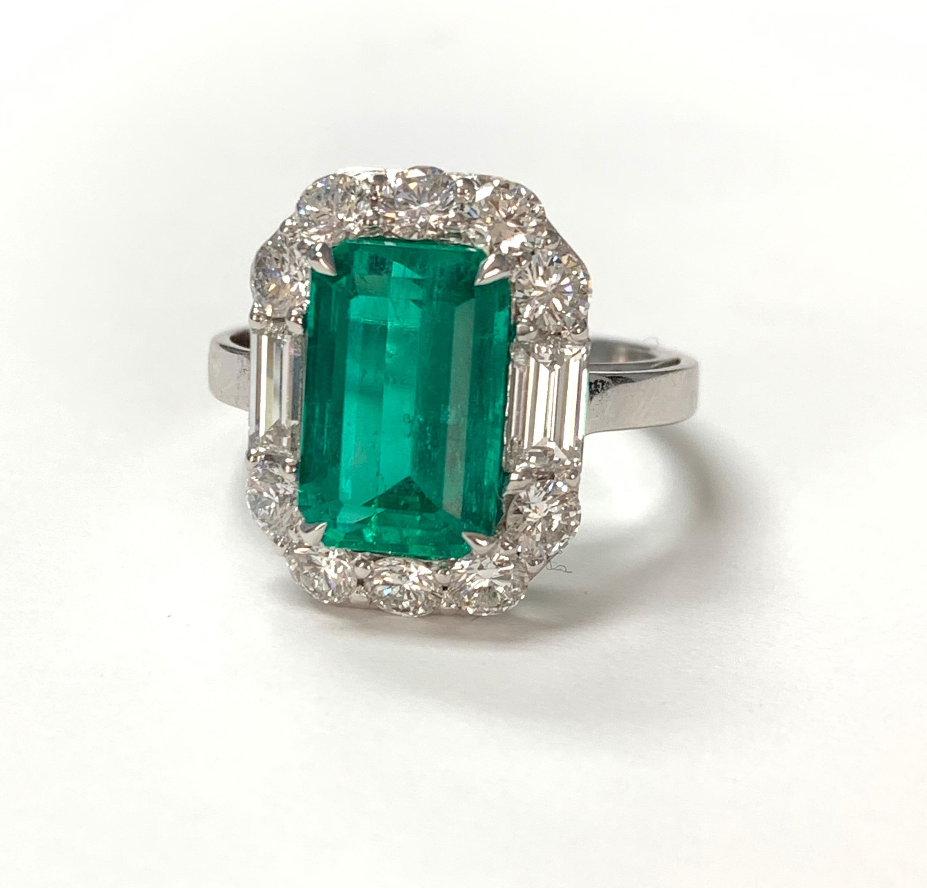 GIA Certified Gorgeously Green Colombian emerald cut emerald and diamond ring hand crafted in 18k white gold. 
The details are as follows : 
Emerald weight : 3.63 Carat 
Diamond weight : 
Baguette diamond : 0.65 carat ( GH color and VS clarity )