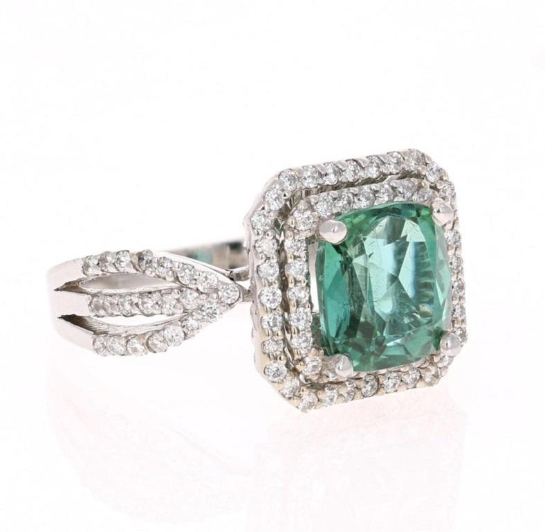 This ring has a 2.99 carat Cushion Cut Green Tourmaline and has 98 Round Cut Diamonds that weigh 0.64 carats. The total carat weight of this ring is 3.63 carats. The tourmaline measures at approximately 9 mm x 8 mm. 

This ring is casted in 14K