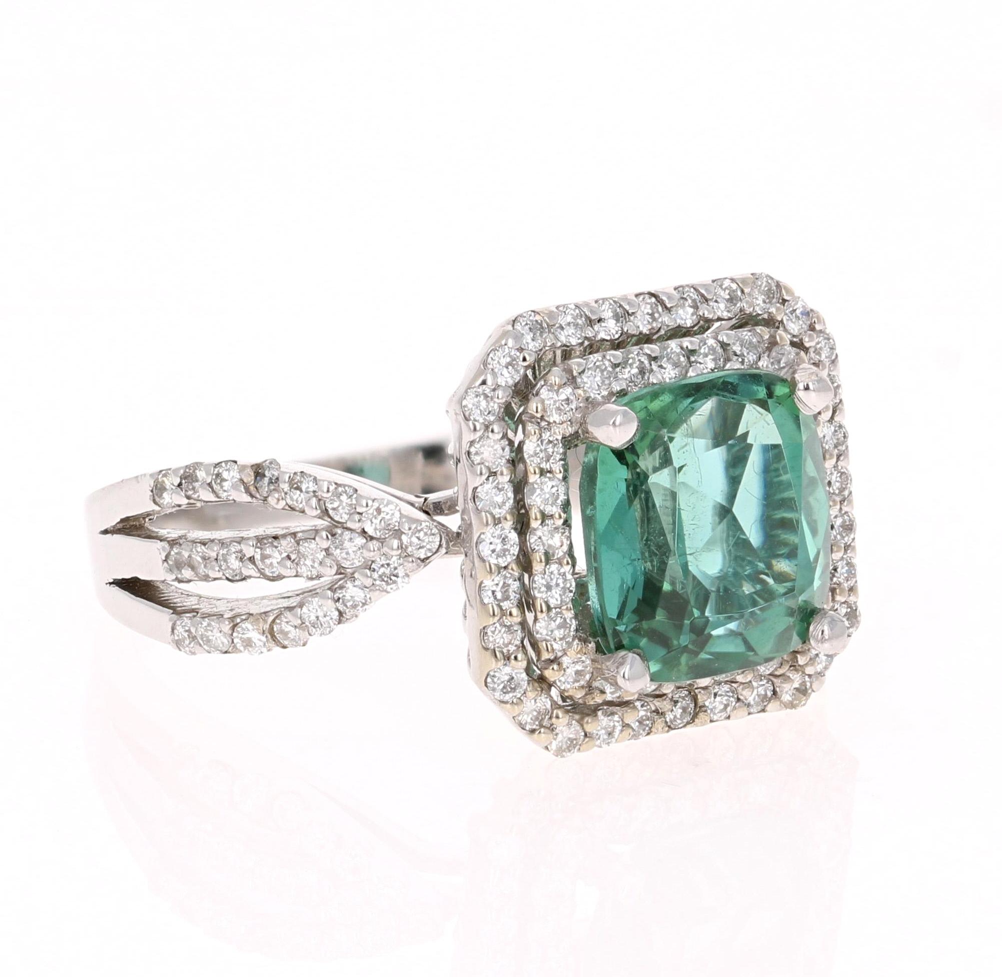 Beautifully designed Green Tourmaline Ring! The beautiful halo setting gives the ring an elegant flow which makes the Green of the Tourmaline stand out brilliantly. 

This ring has a 2.99 carat Cushion Cut Green Tourmaline and has 98 Round Cut