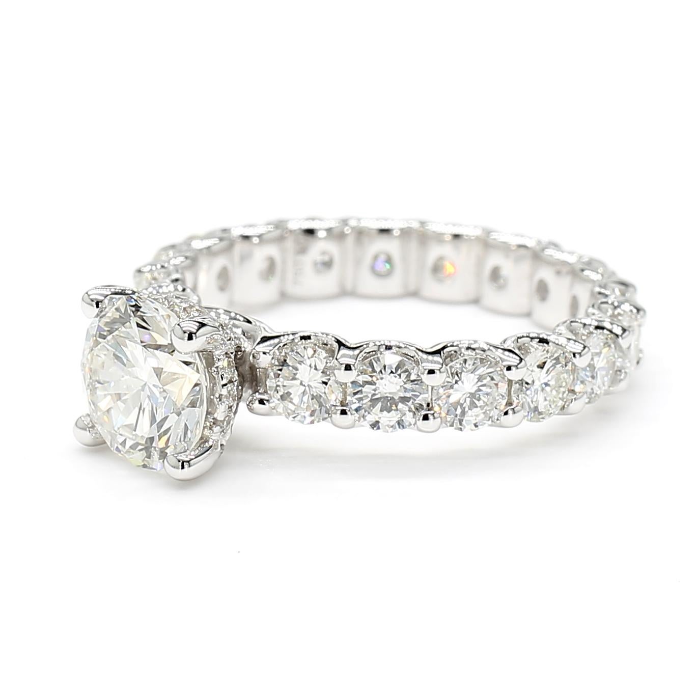 This GIA Certified *Round Diamond Engagement Ring* complimented by an Eternity Halo Band is a testament to fine craftsmanship and timeless design. Perfect for those who appreciate the beauty of natural diamonds, this ring offers a balance of luxury