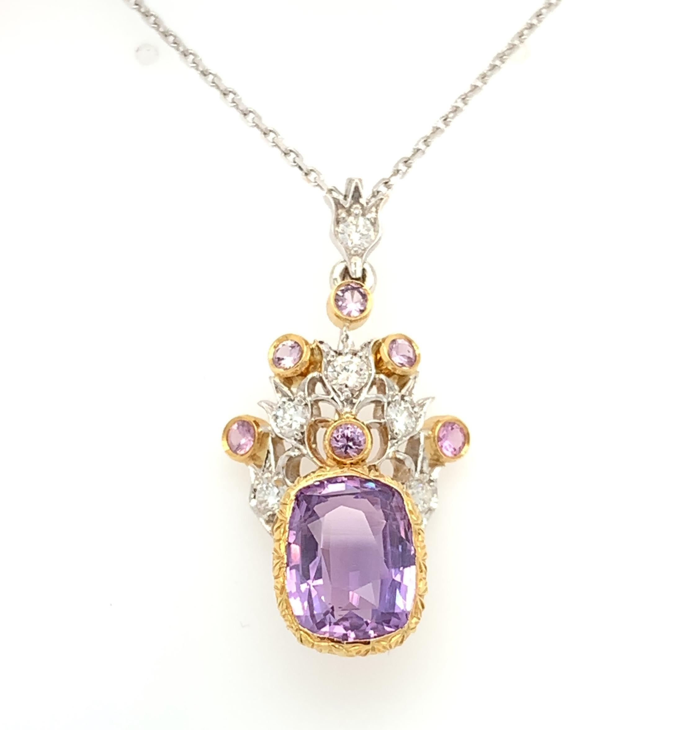 This one-of-a-kind pendant features a bright cushion-cut sapphire with a gorgeous lavender color. Set with pink sapphires and sparkling diamonds, this is a regal design you will want to wear time and time again. Handmade in 18k yellow and white gold