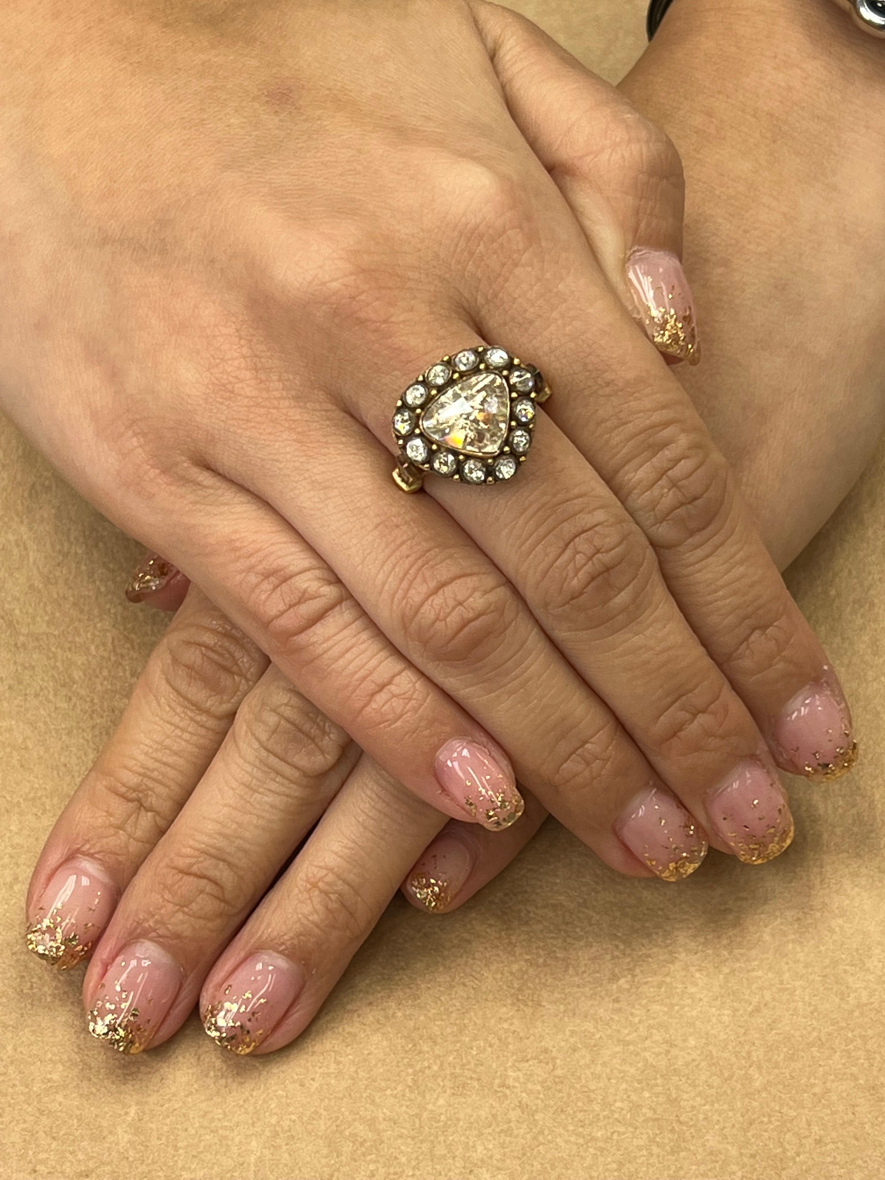 Please check out the HD video. This is a newly made ring using older materials. This ring has a great antique feel and look. The ring is set in 18k rose / yellow gold and diamonds. The center triangle rose cut diamond is about 2.05 Cts, there are an