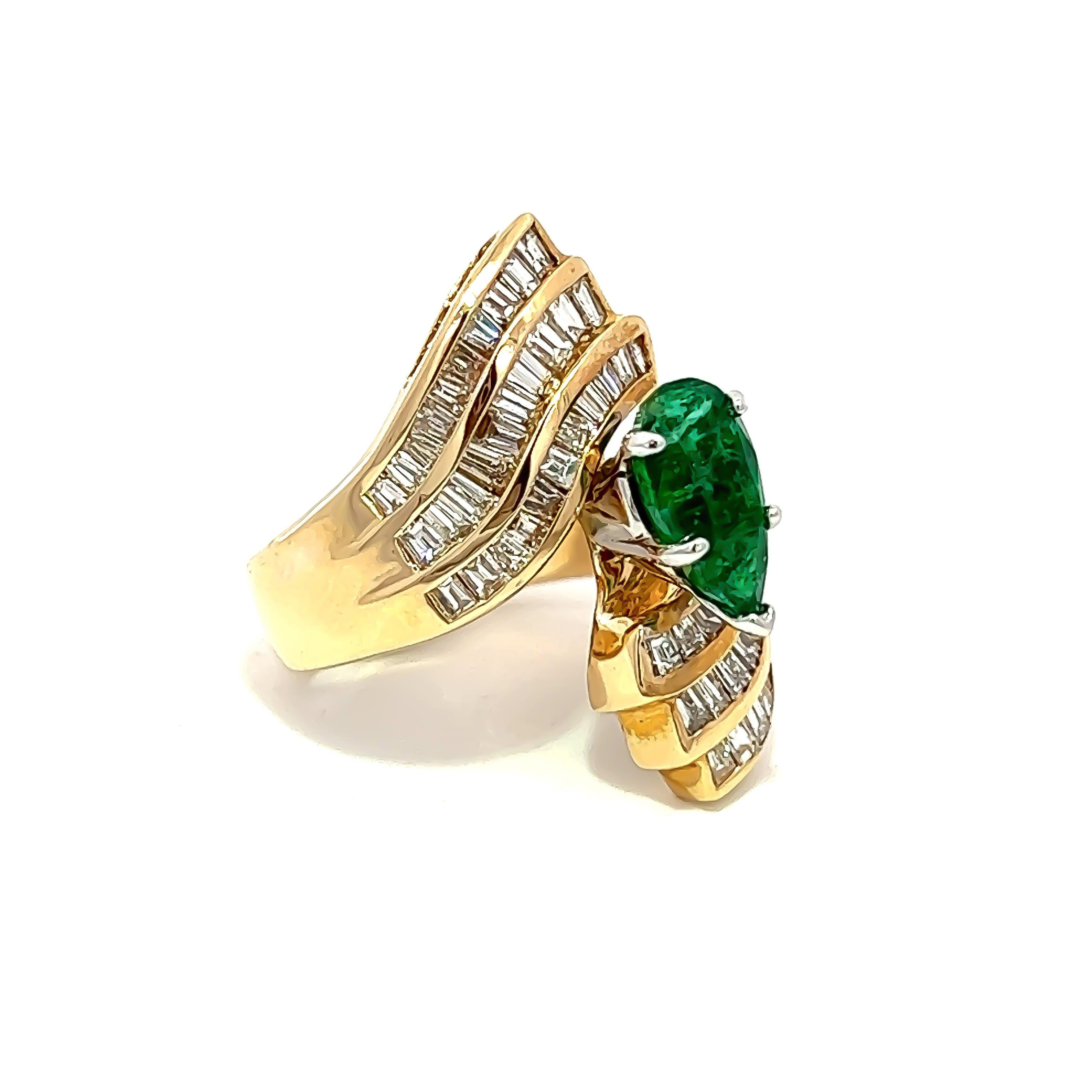 Indulge in luxury with this impeccable cocktail ring, skillfully crafted from 14k yellow gold and adorned with a breathtaking 1.53ct Emerald centerpiece. The ring is beautifully accented with 2.10CT Baguette diamonds that elegantly encircle both the