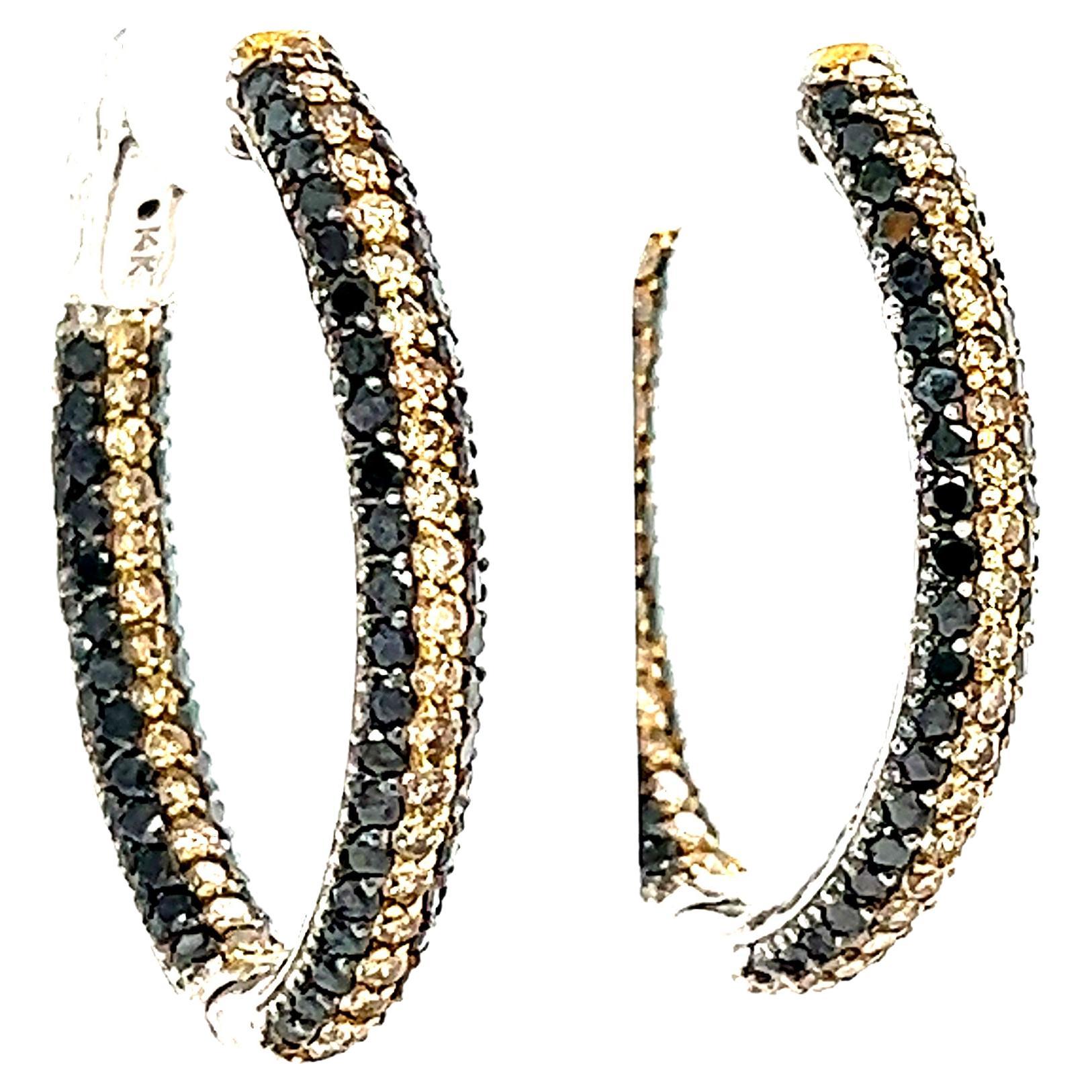These stunning hoop earrings have Natural Round Cut Champagne Diamonds that weigh 1.41 and Natural Black Round Cut Diamonds that weigh 2.23 Carats. The total carat weight of the hoops are 3.64 Carats. The hoops are just under 1 inch wide and just