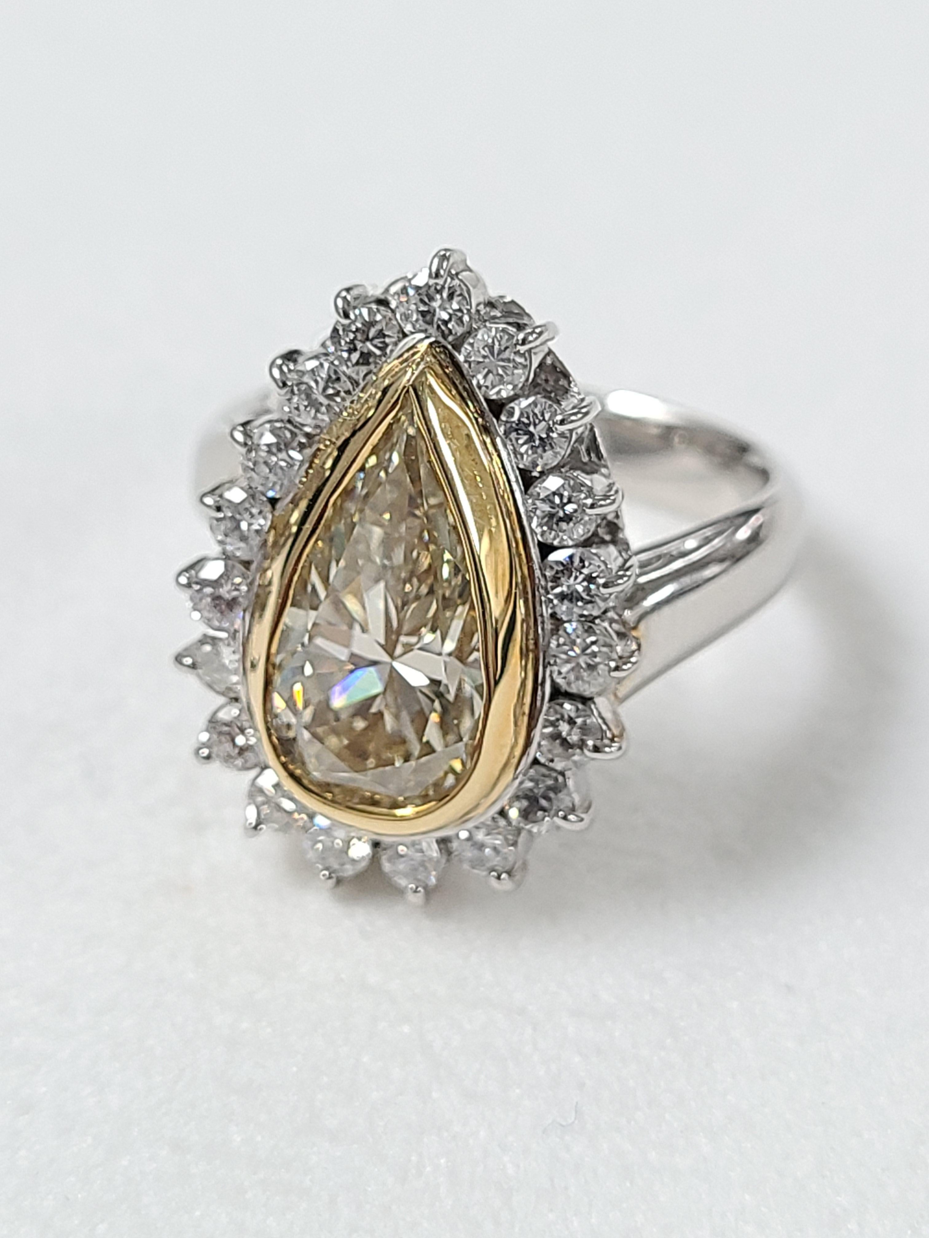 A gorgeous and Art deco style ring . The centre Pear diamond is 3.64 carat surrounded by smaller .81 carat diamond . The ring dimension in cm 1.8 x 1.4 x 2.5 . US size 7 1/2. Clarity SI2 Color Light Yellow .
