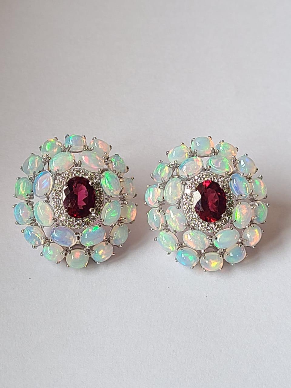 A very  beautiful and one of a kind, Rubellite & Ethiopian Opal Studs / Lever-back Earrings set in 18K Gold & Diamonds. The weight of the Rubellite is 3.64 carats. The weight of the Opal Cabochons is 12.30 carats. The opals are of Ethiopian origin.