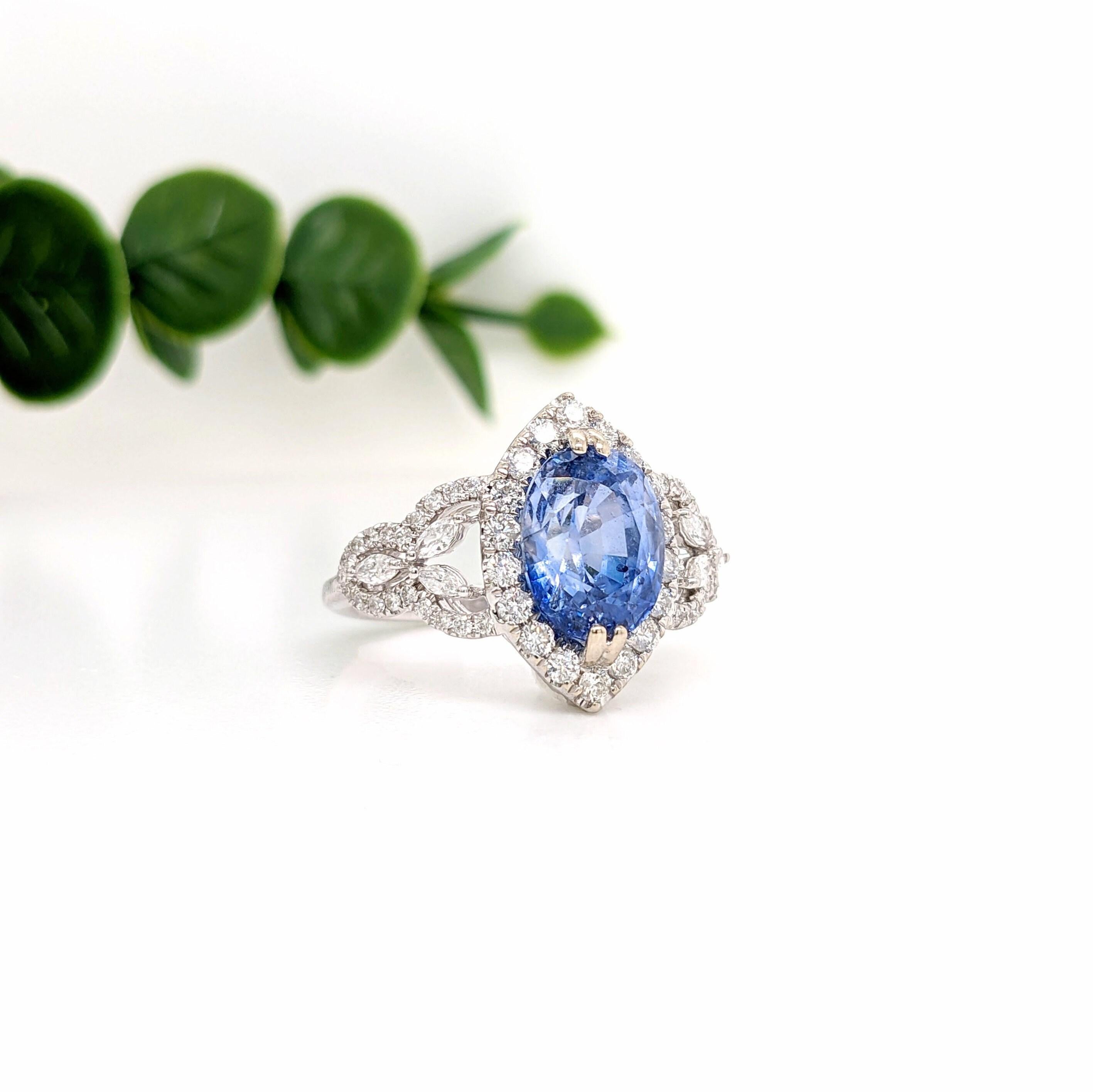 This stunning statement ring features a sparkling Ceylon Sapphire in 14k white gold with a diamond halo and fancy diamond accent shank . A art deco ring design perfect for an eye catching engagement or anniversary. This ring also makes a beautiful