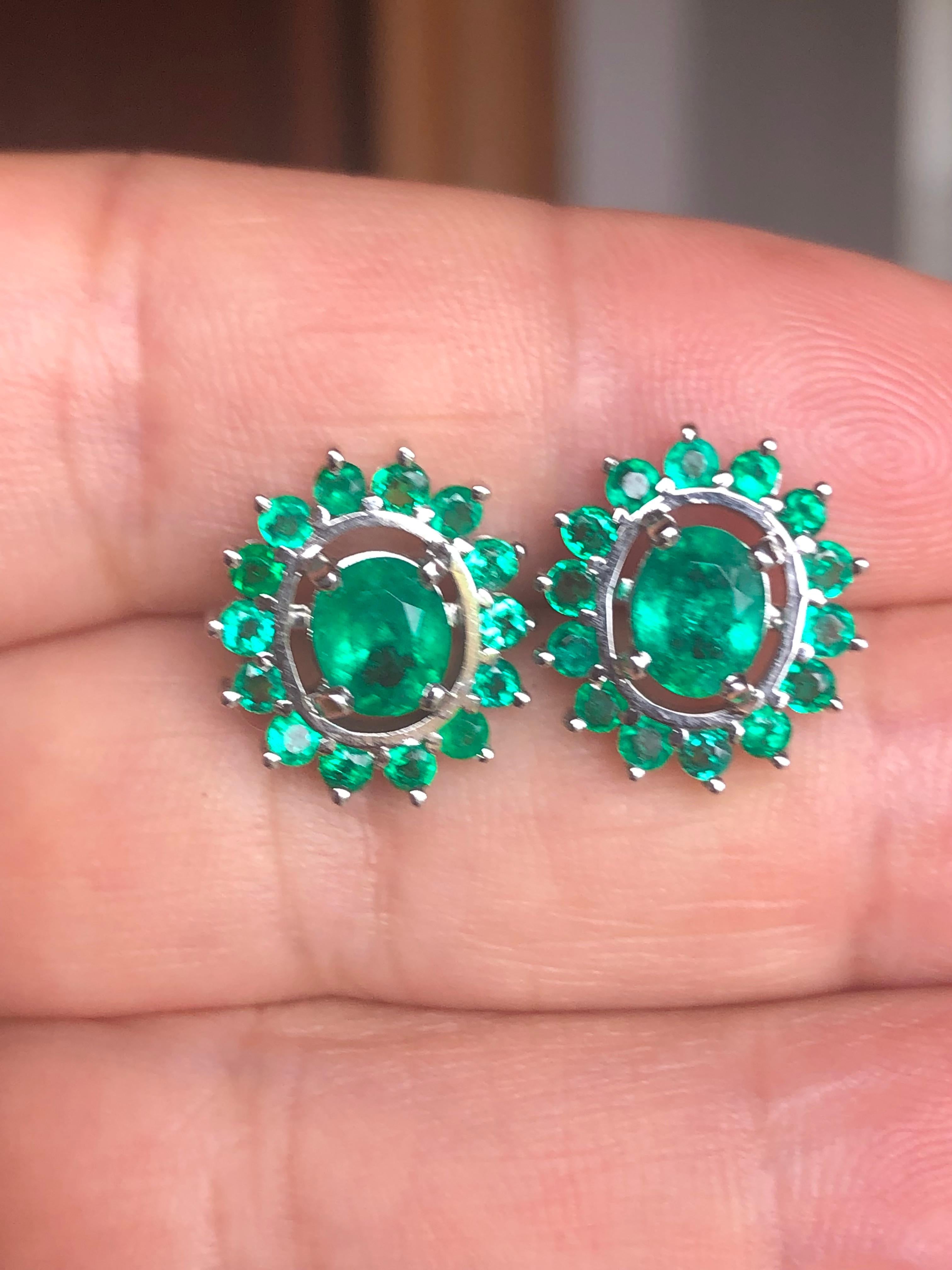 18k earrings with 2 oval-shaped Colombian emeralds weighing Approx. 2.20 carats and 28 round Colombian emeralds weighing 1.36 carats. The beauty of heart shapes- perfectly matched Colombian emeralds are exquisitely handcrafted 18K white gold